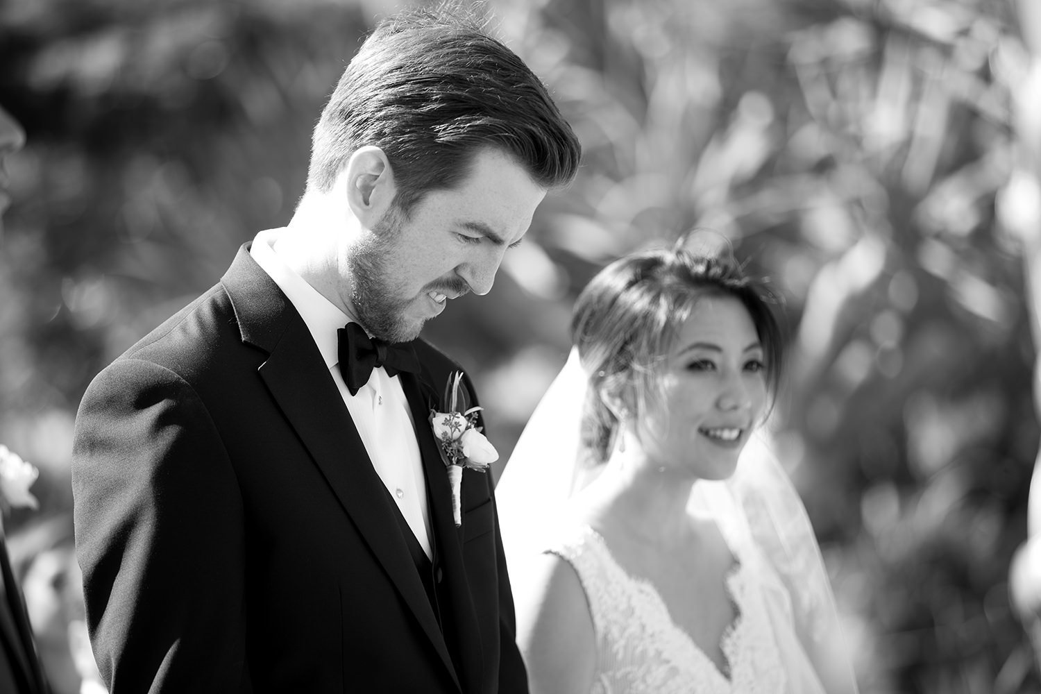 black and white image of bride and groom at ceremony