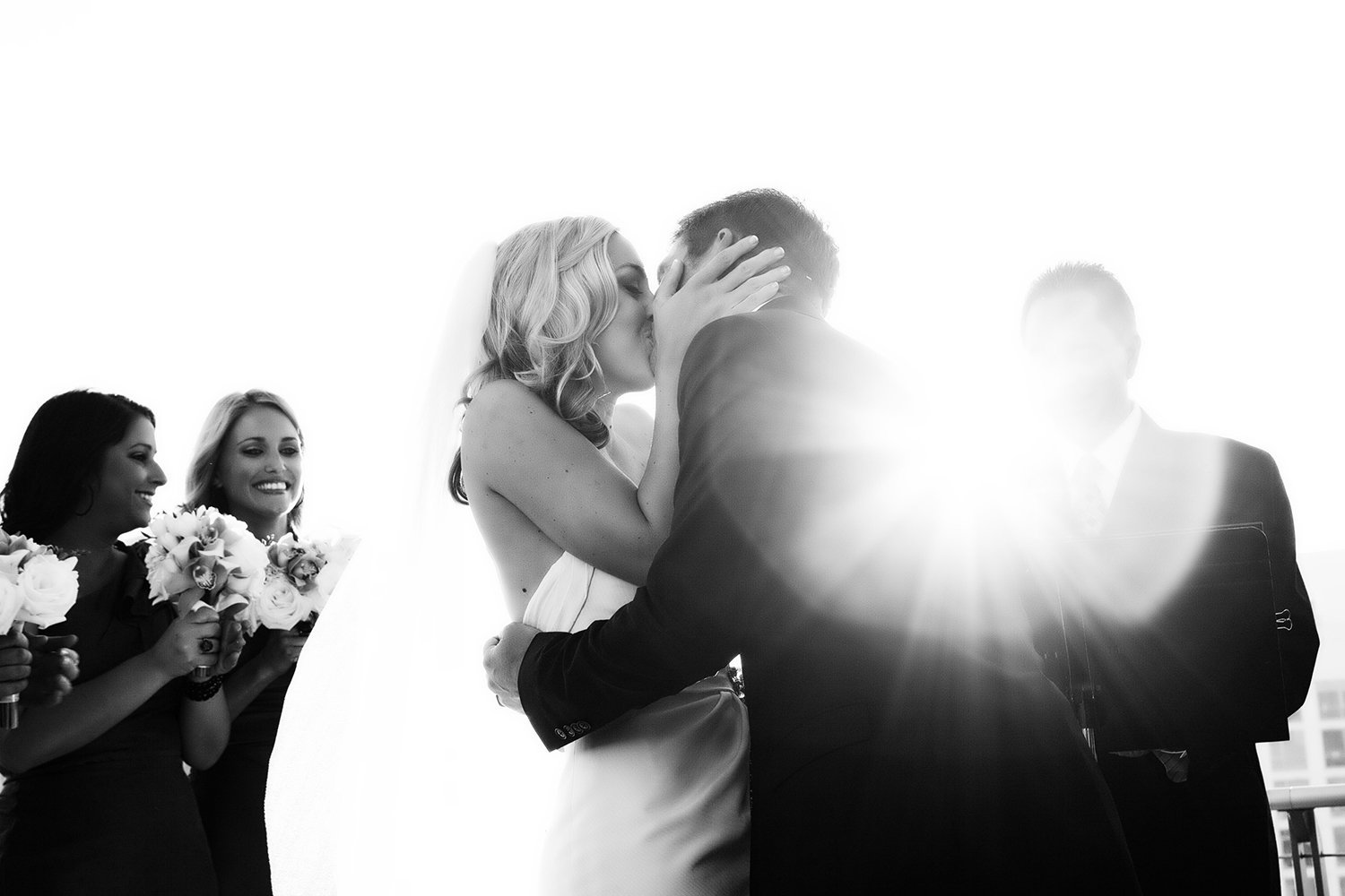 The Ultimate Skybox wedding photos bride and groom kiss at ceremony