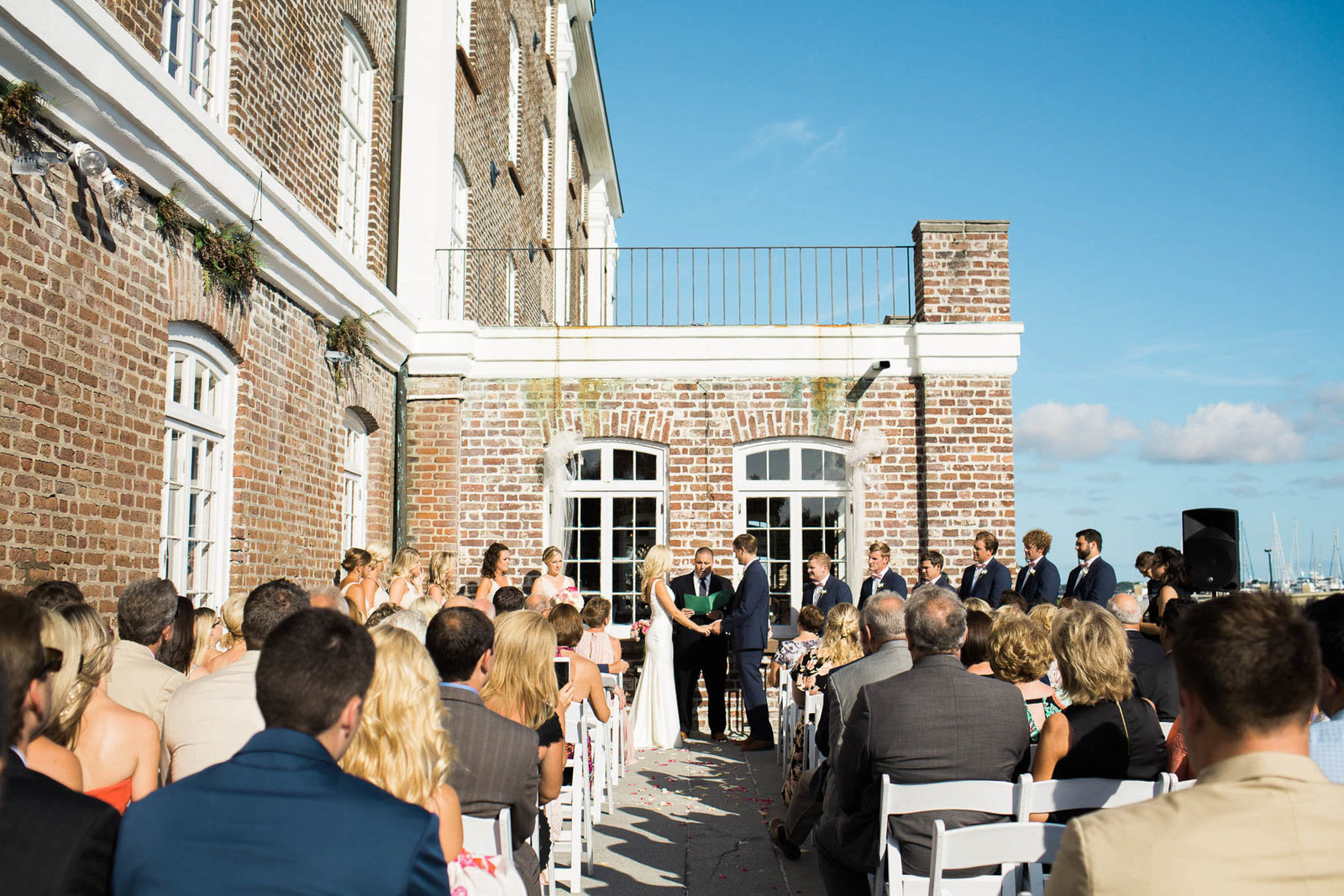Bride and groom exchange vows, Rice Mill Building, Charleston, South Carolina