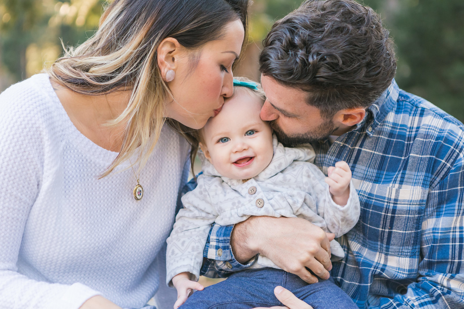 Parents kissing baby in  Grass Valley CA Family Session