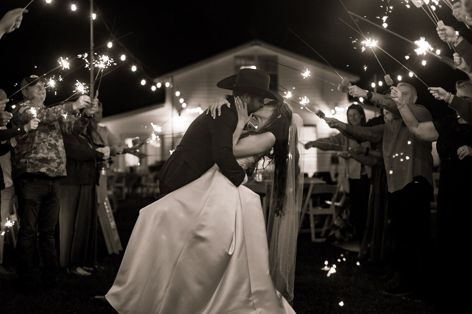 couple kissing during a sparkler exit at their wedding in Jacksonville Florida