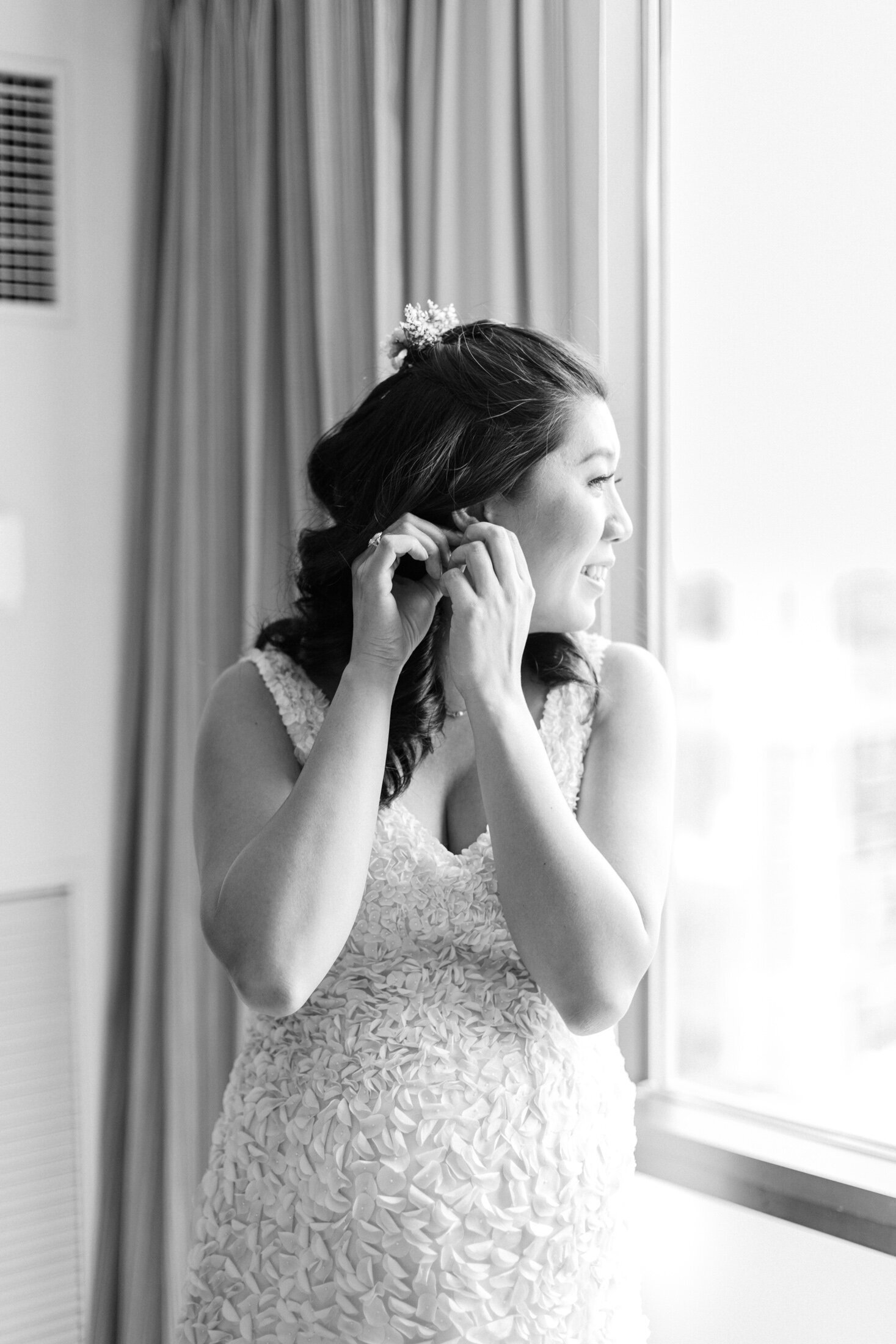Bride puts in earrings as she looks out over DC