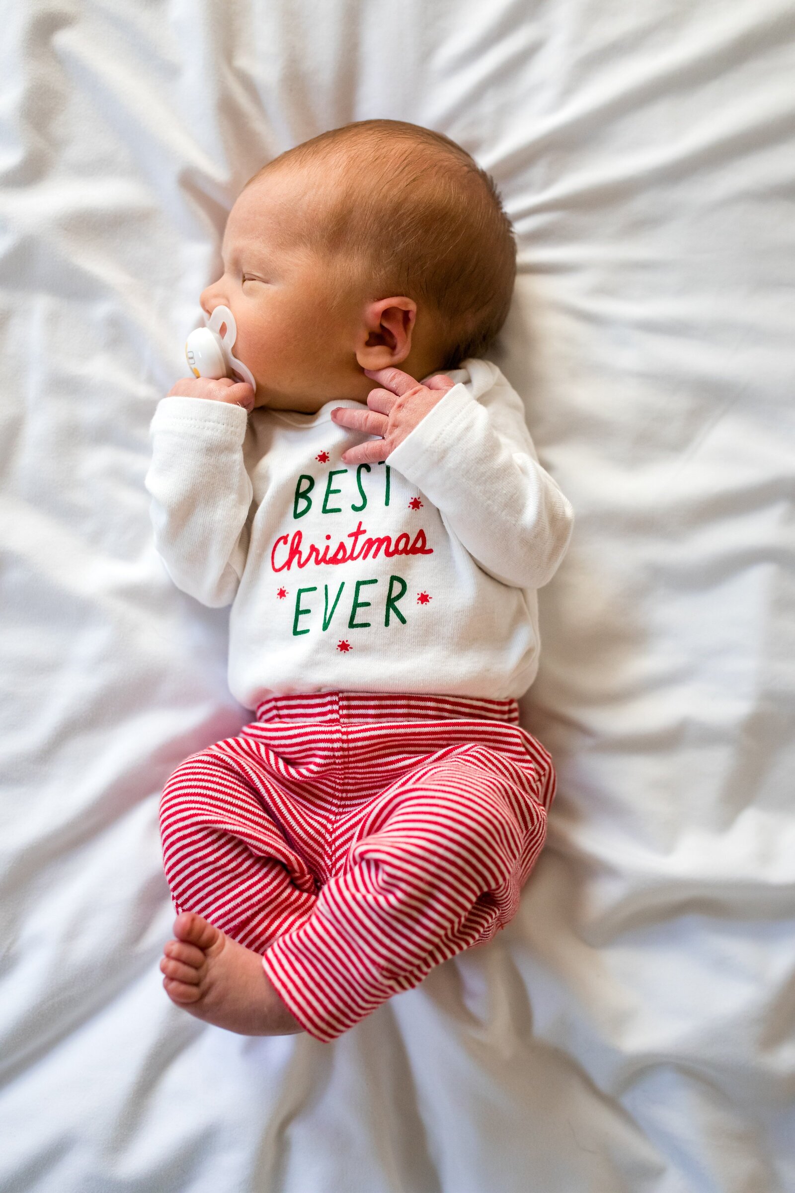 Newborn wearing Best Christmas Ever shirt