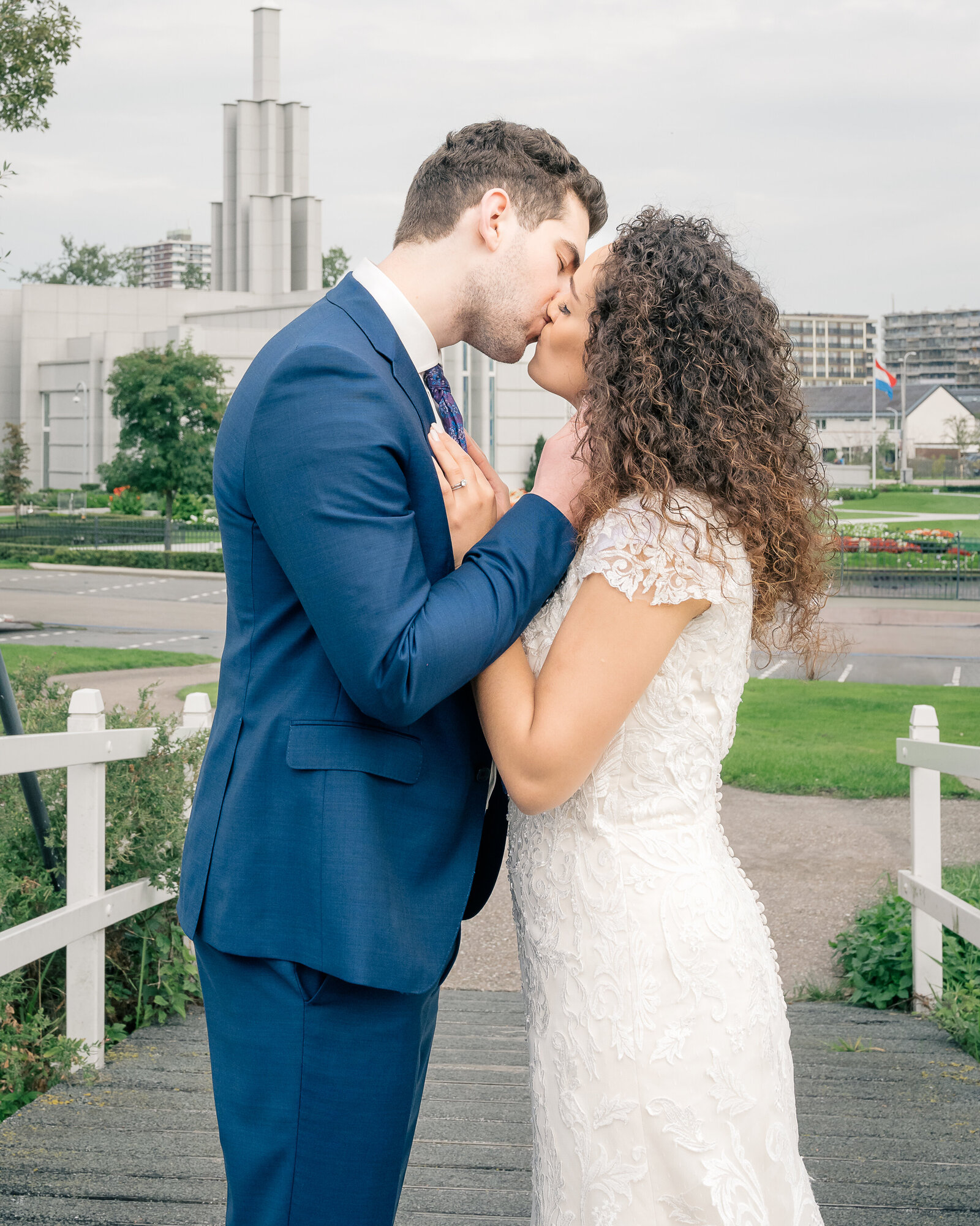 After the sealing in the Church of Jesus Christ temple in the Hague, bride Naomi and groom John share a kiss on the traditional Dutch bridge nearby
