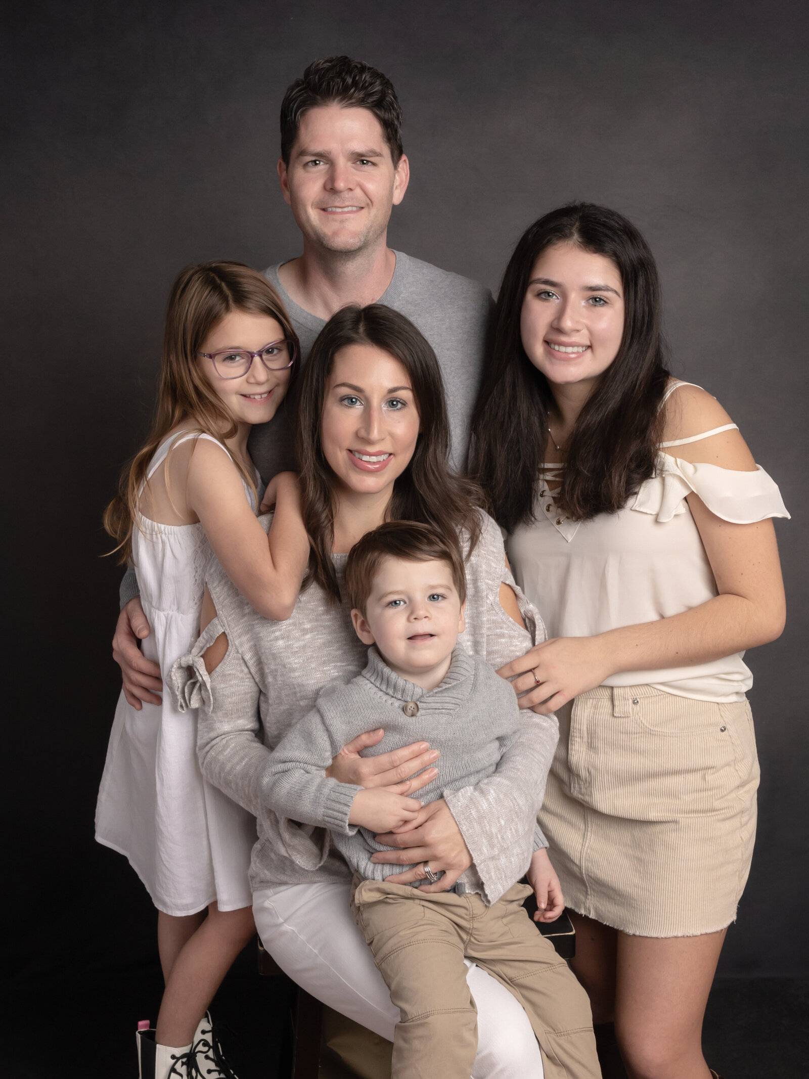 mother, father and three children posing for studio portraits cleveland family photography