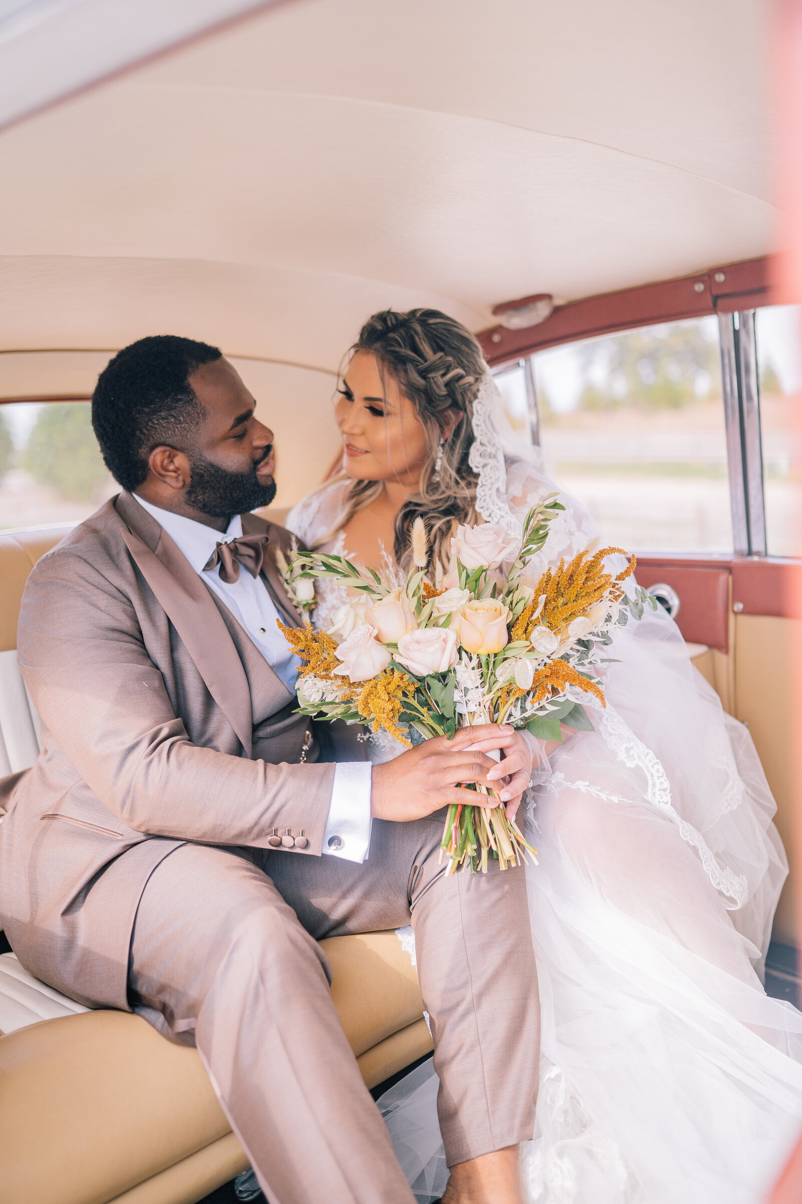 Sacramento Wedding Photographer captures bride sitting with groom in vintage car