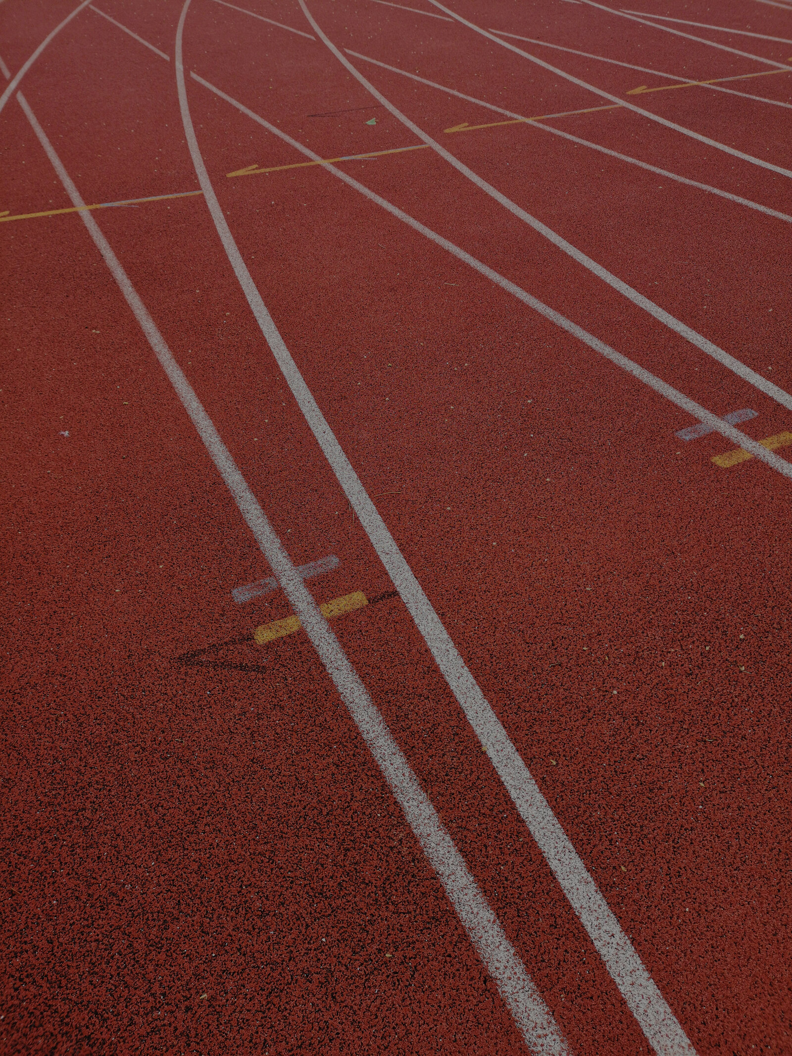 Close-up of a red track with white painted lines