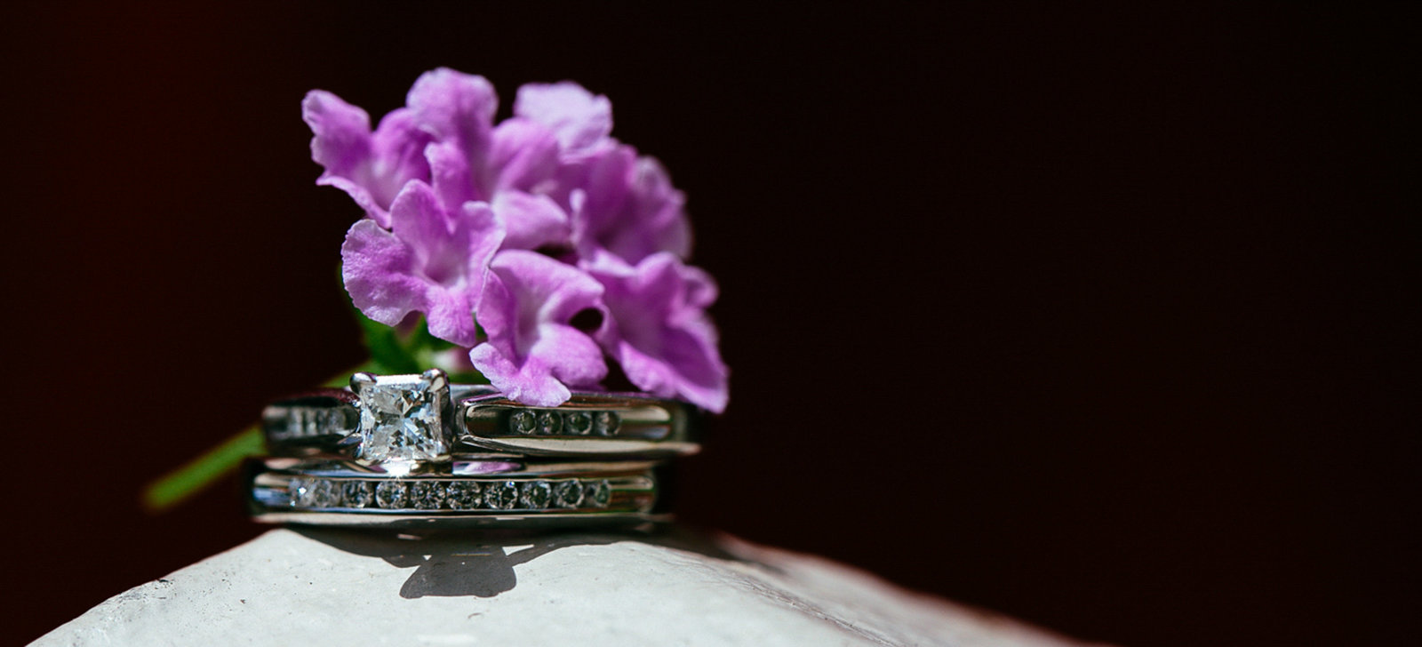 Close up of wedding rings with flower. Photo by Ross Photography, Trinidad, W.I..