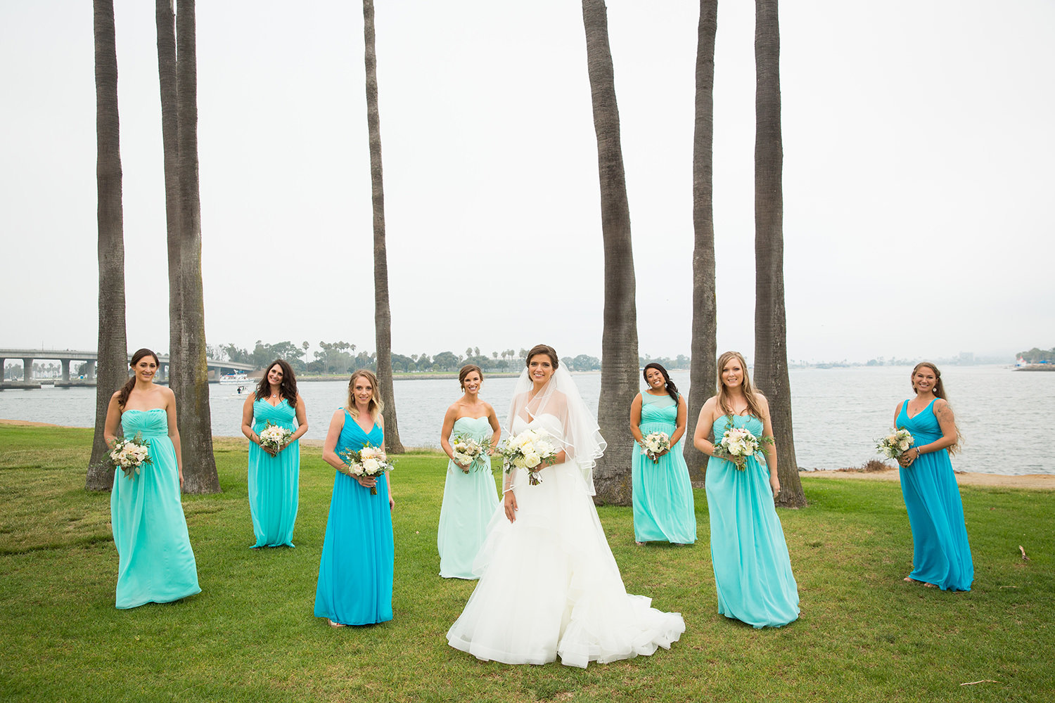 bridesmaids in teal and coral dresses
