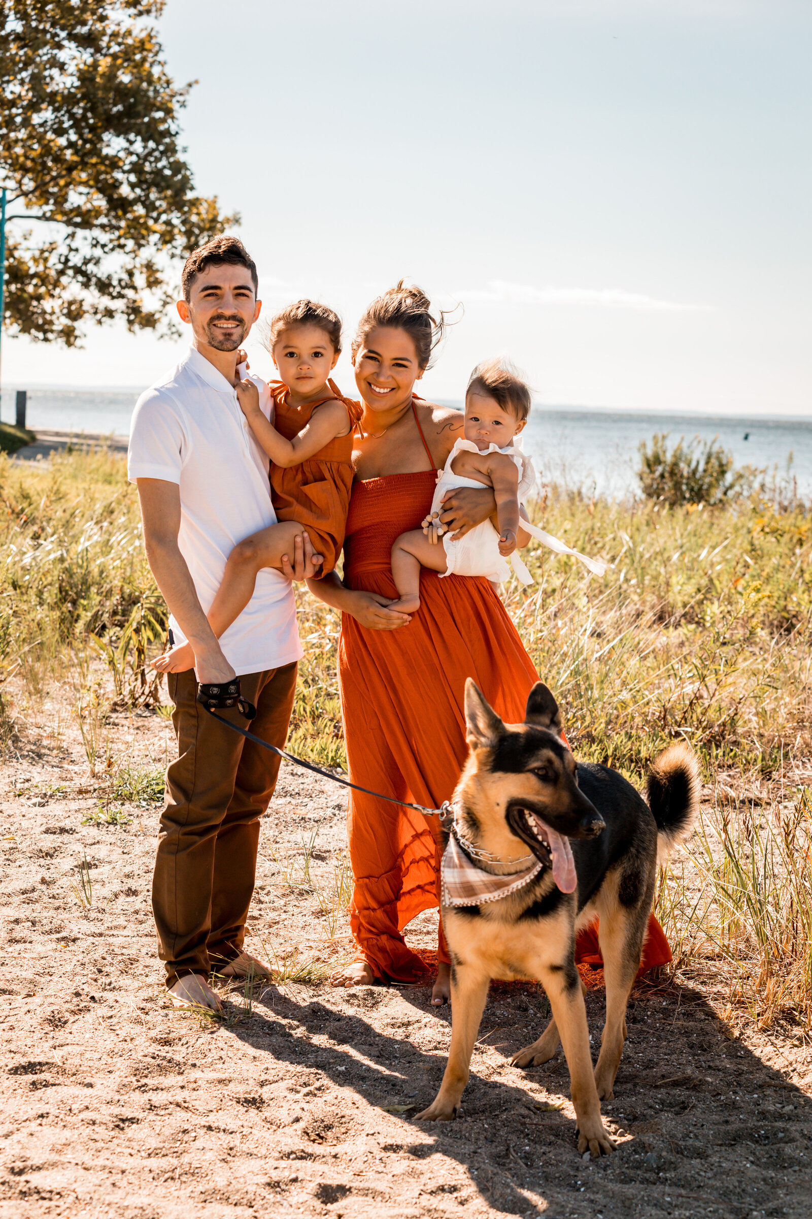 family smiling at their beach photoshoot in bridgeport connecticut