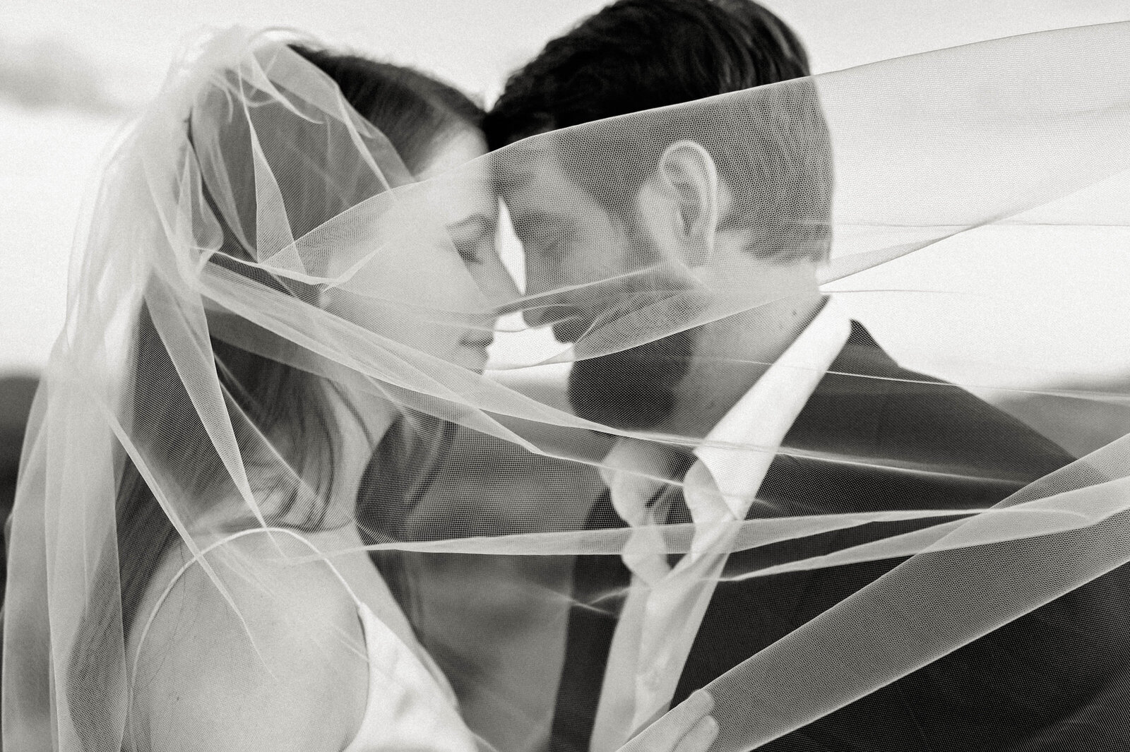 Wedding Couple with veil surrounding them