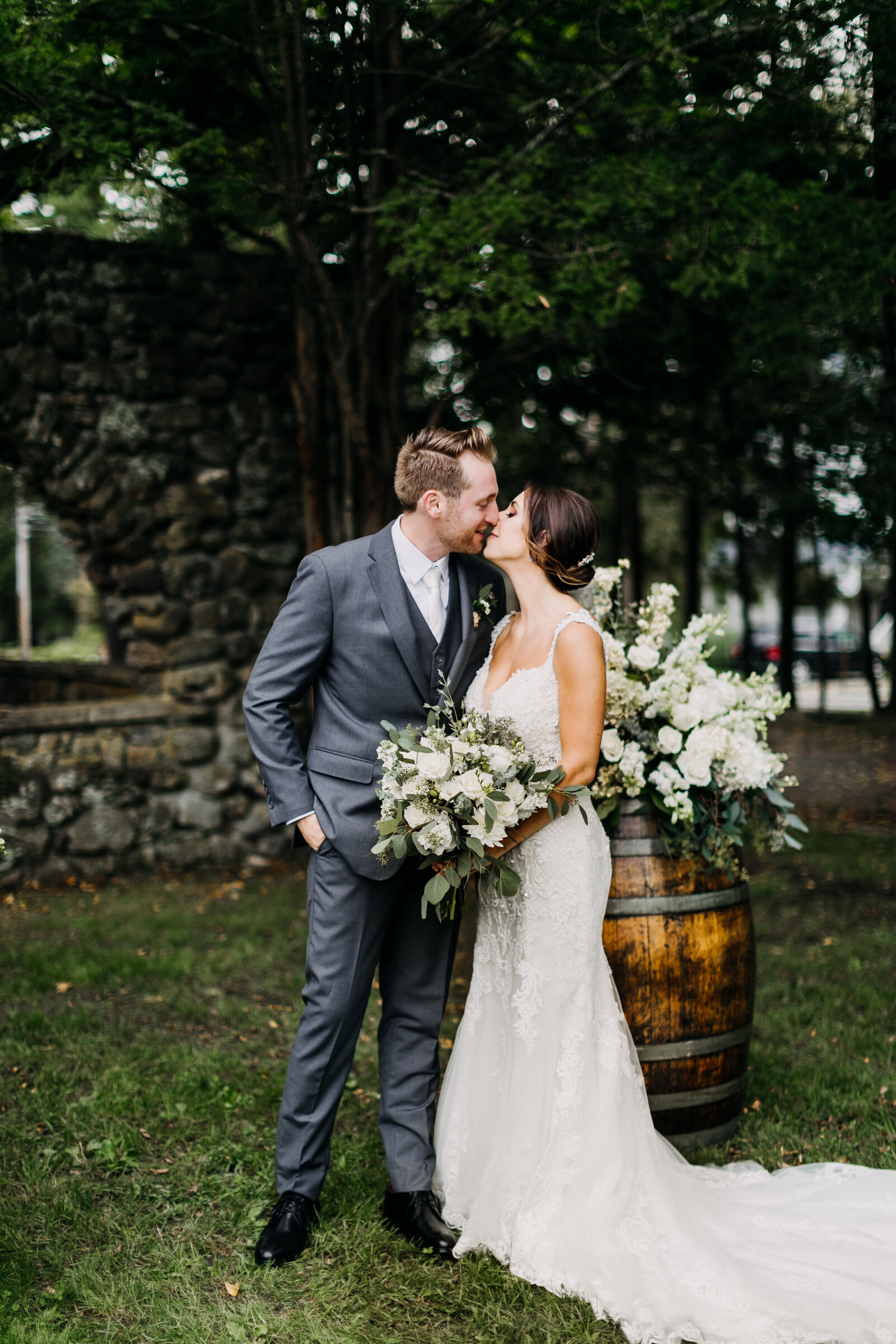 bride and groom kissing at winery