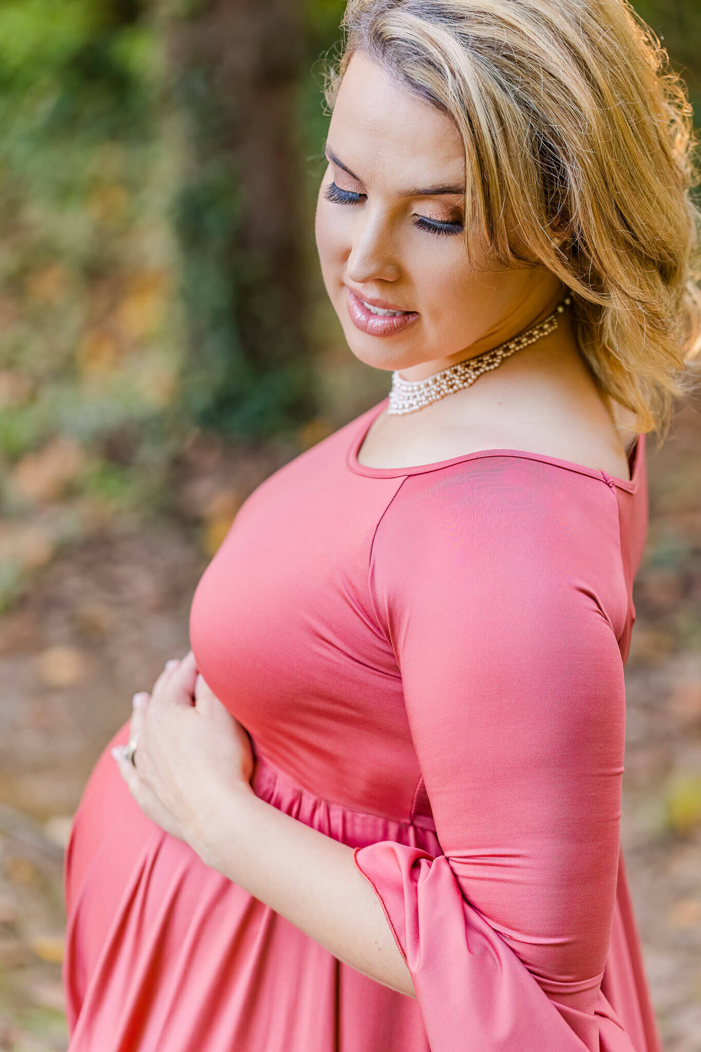 A pregnant woman embracing her belly at her Fairfax maternity session.
