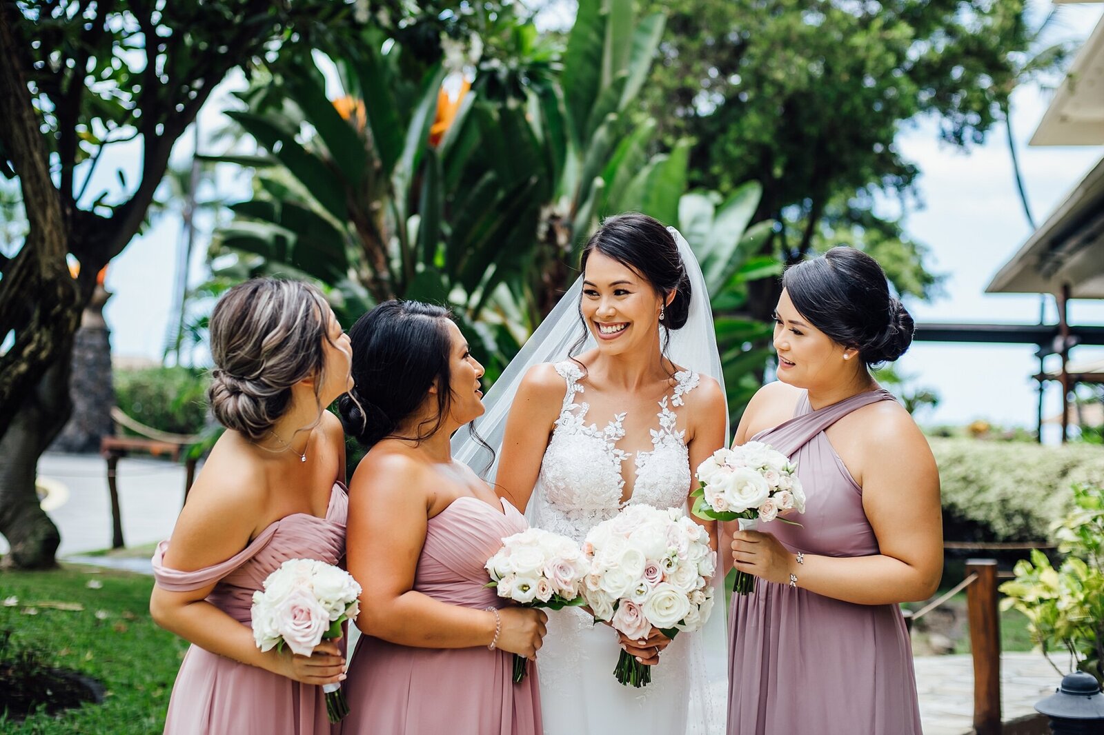bride and bridesmaids smiling during this hawaii big island wedding
