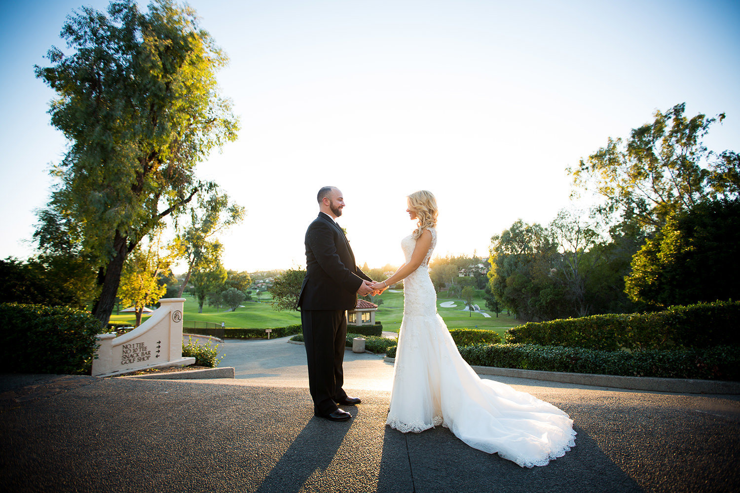 Bride and groom hold hands with stunning view at Rancho Bernardo Inn