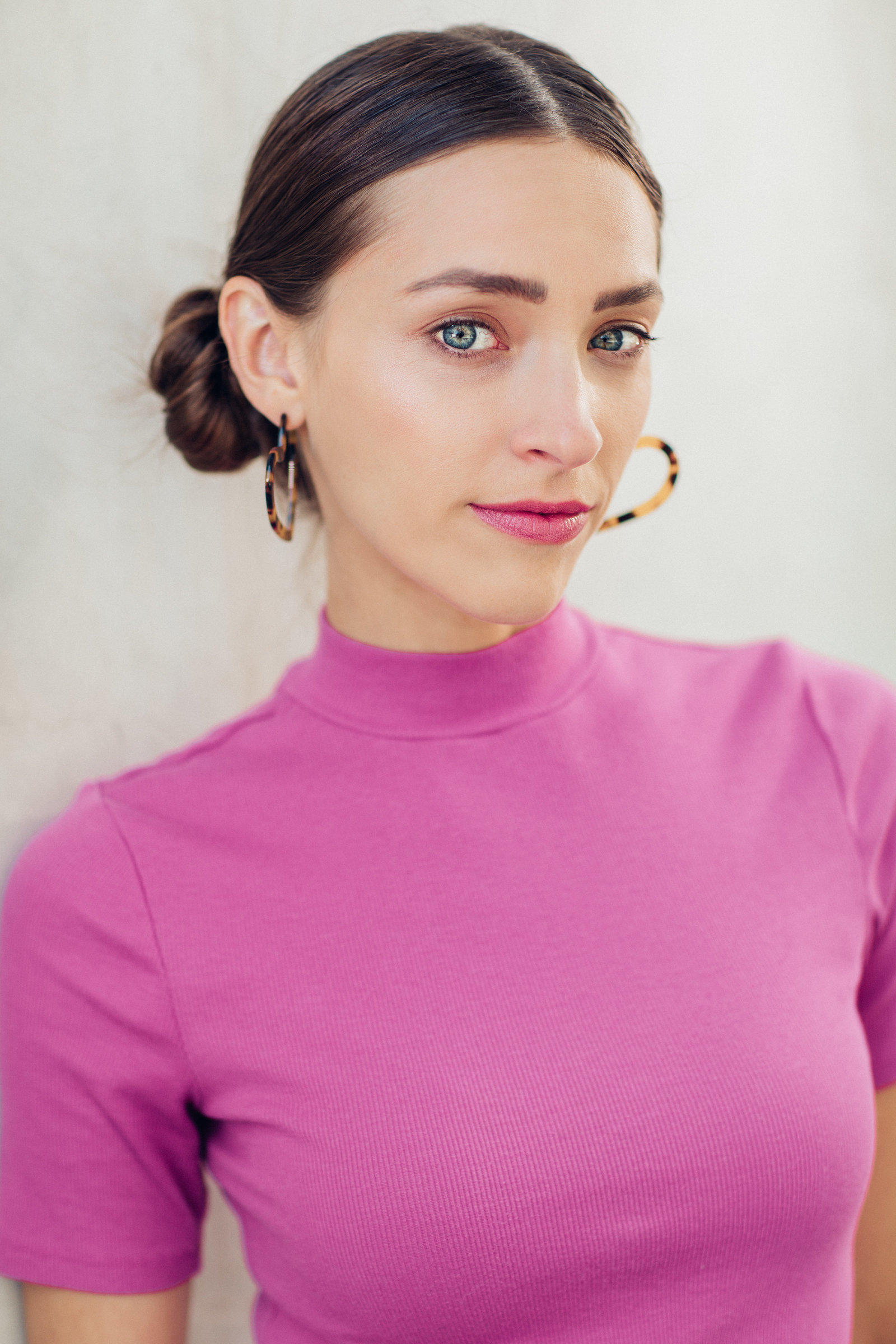 Headshot Photo Of Young Woman In Pink Turtle Neck Shirt