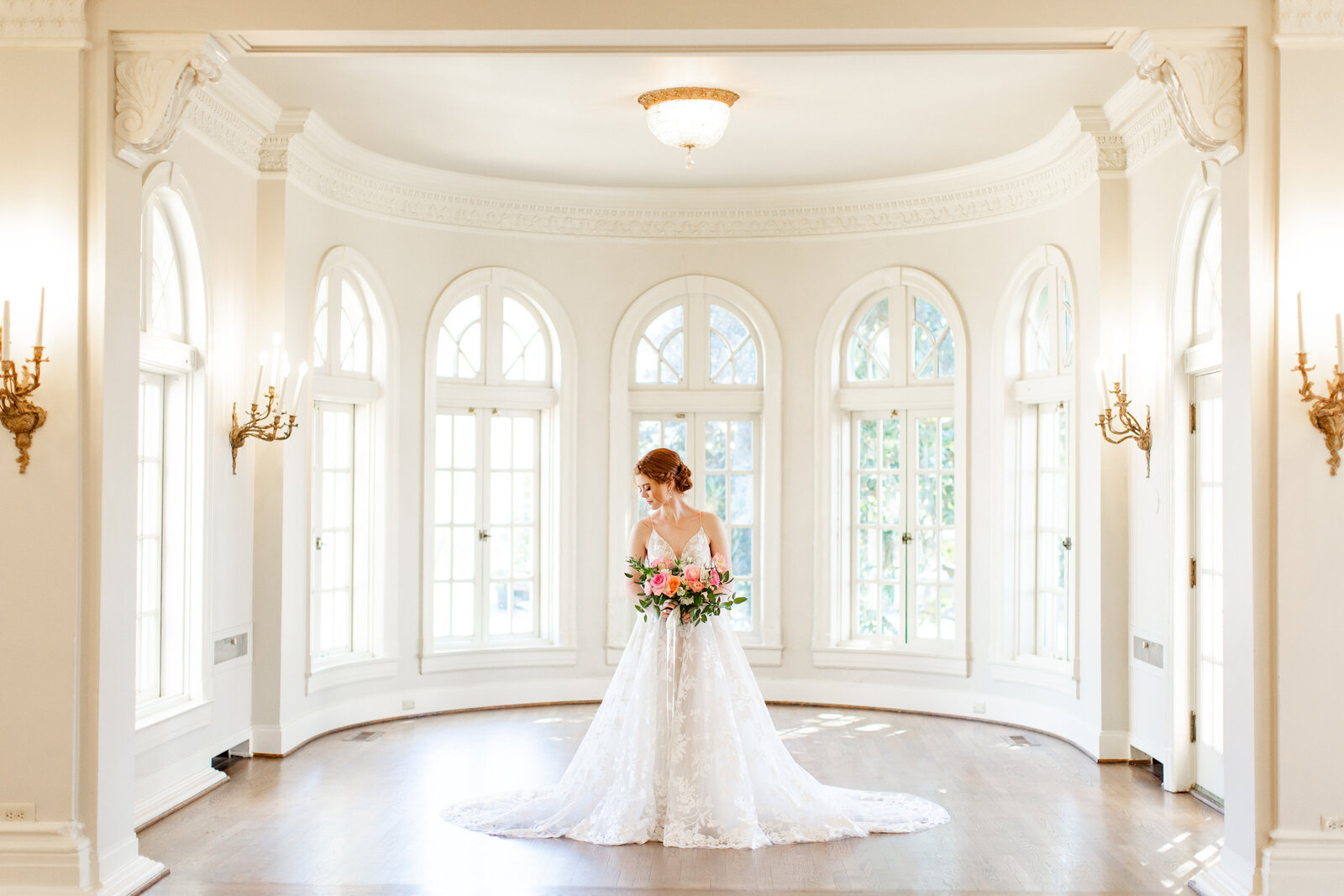 Bride standing in the rotunda room at The Mansion at Woodward Park in her Ellis bridal wedding dress.
