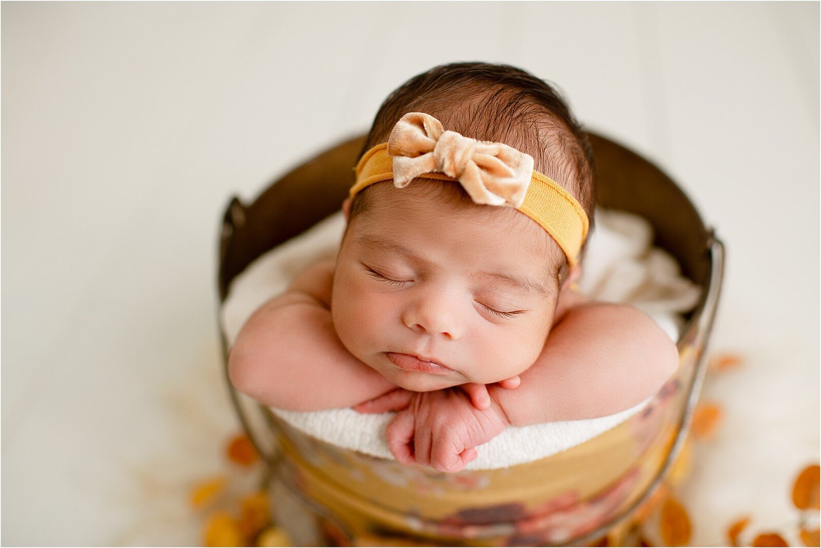 newborn baby in yellow floral bucket
