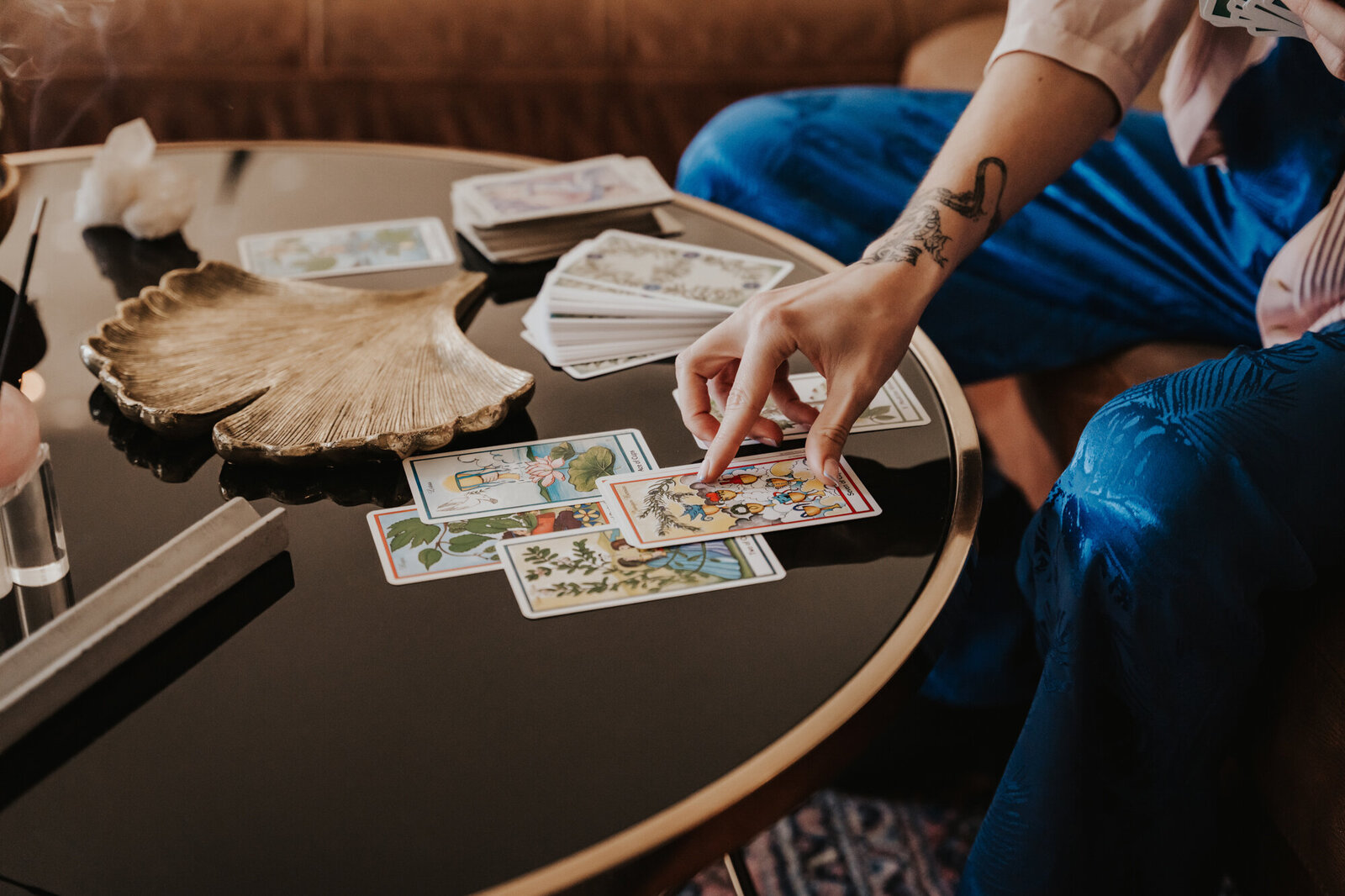 Branding Photographer, someone lays a series of tarot cards on a small table
