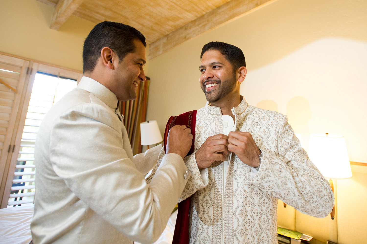 Groom getting help into his Sherwani before his Hindu wedding ceremony