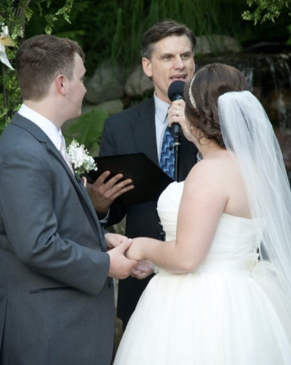 bride and groom hold hands as they take their wedding vows