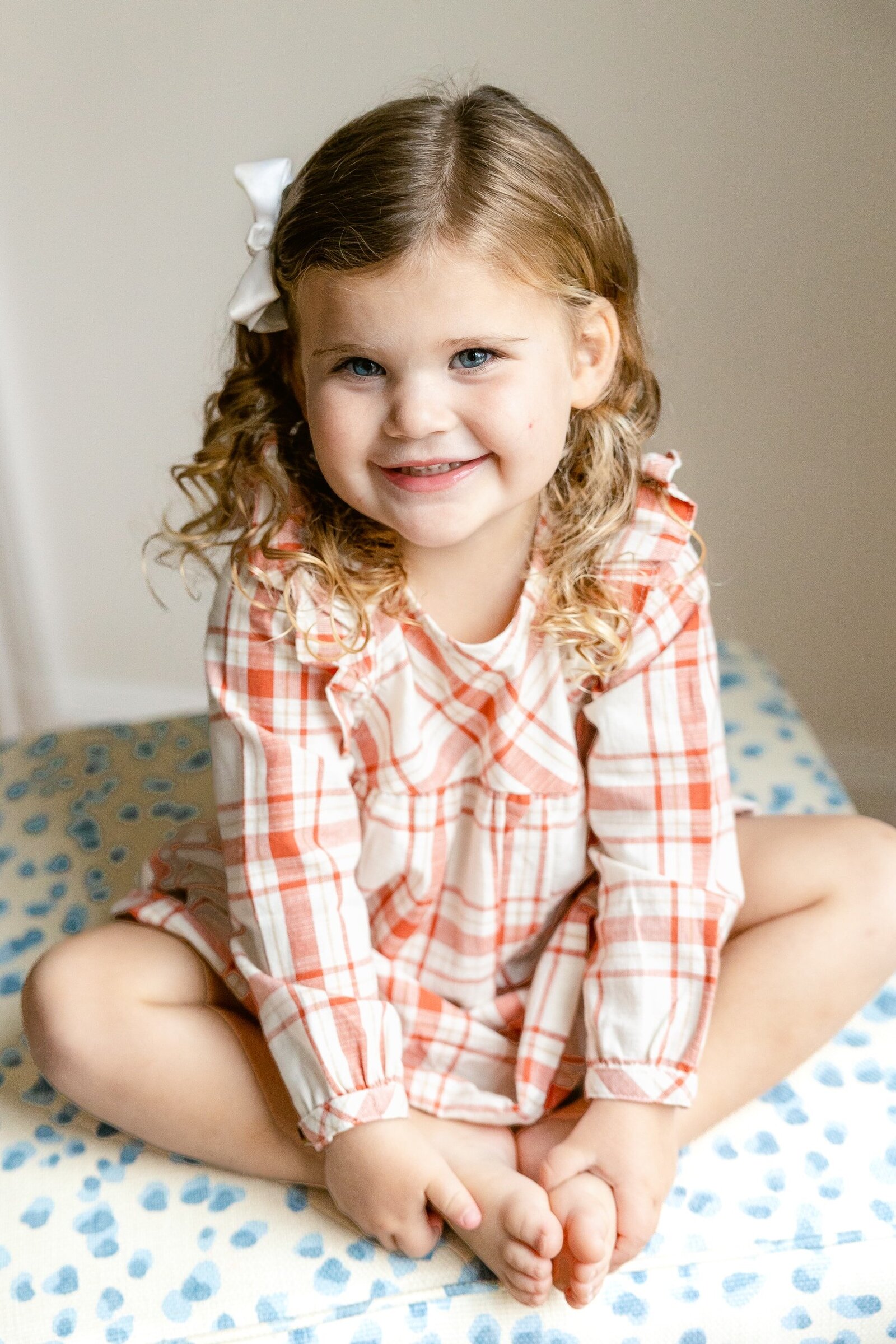 young girl in plaid pink dress