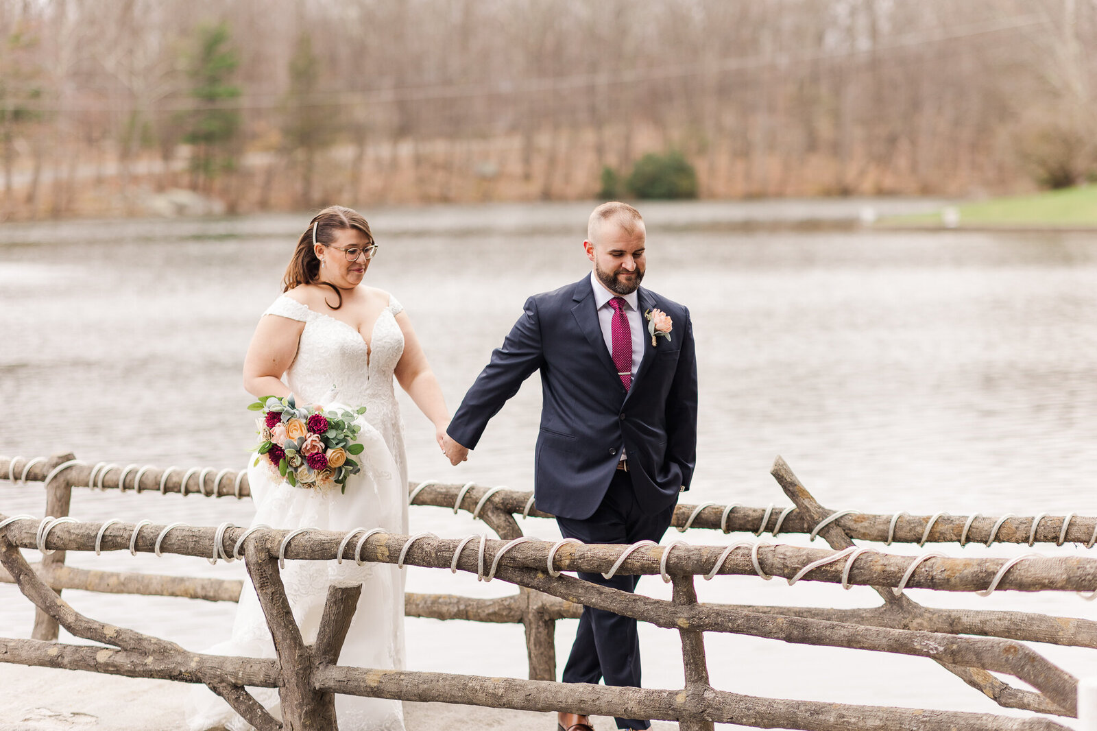 groom and bride walking on bridge