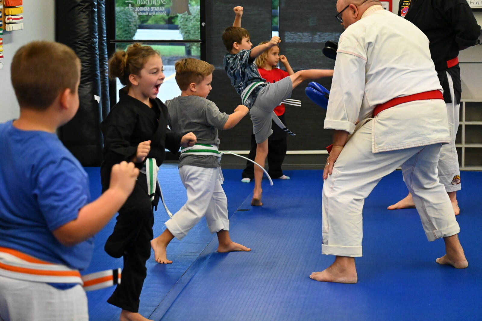 Kids practicing karate with instructors