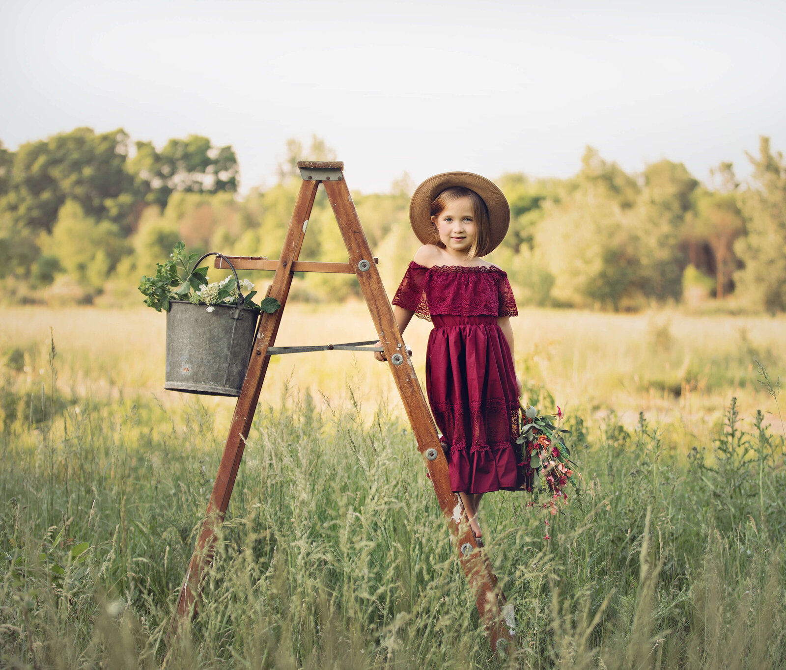 Photo of a child in a field standing on a ladder in Erie Pa