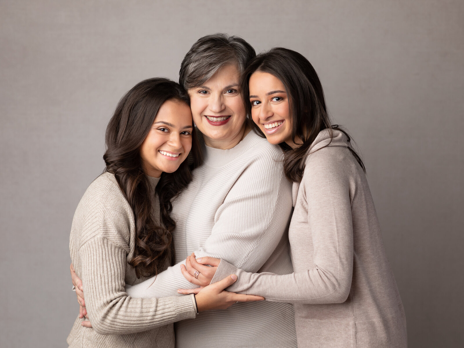grandma and two granddaughters posed for studio portraits