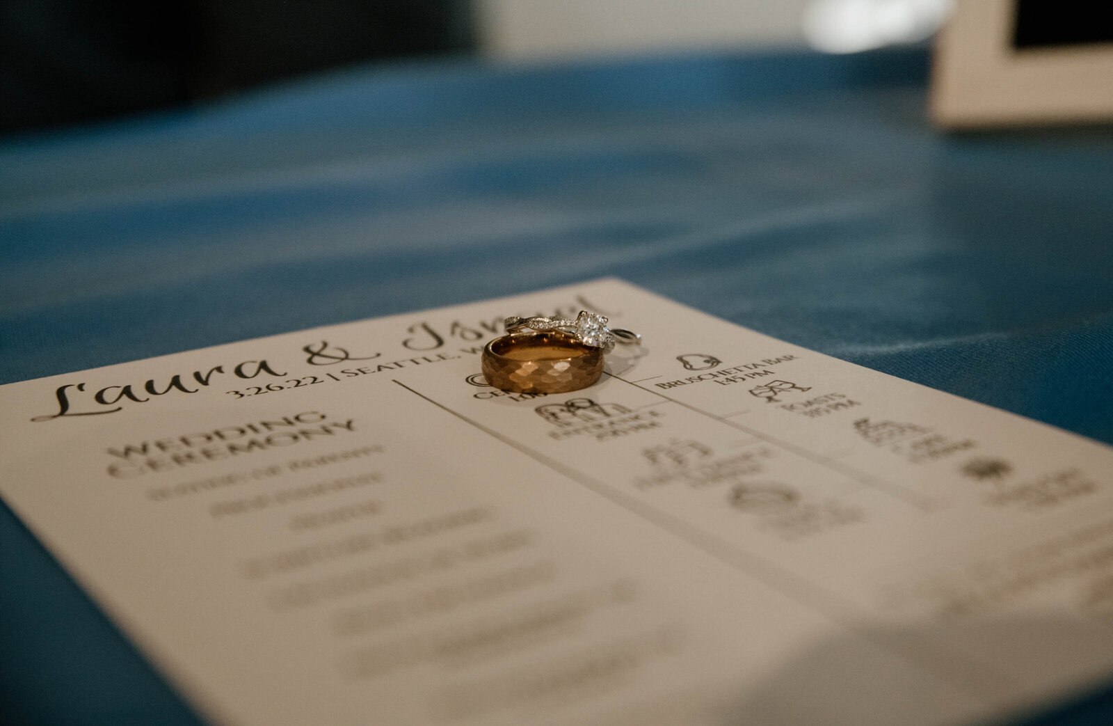 Close up of rings and wedding program.