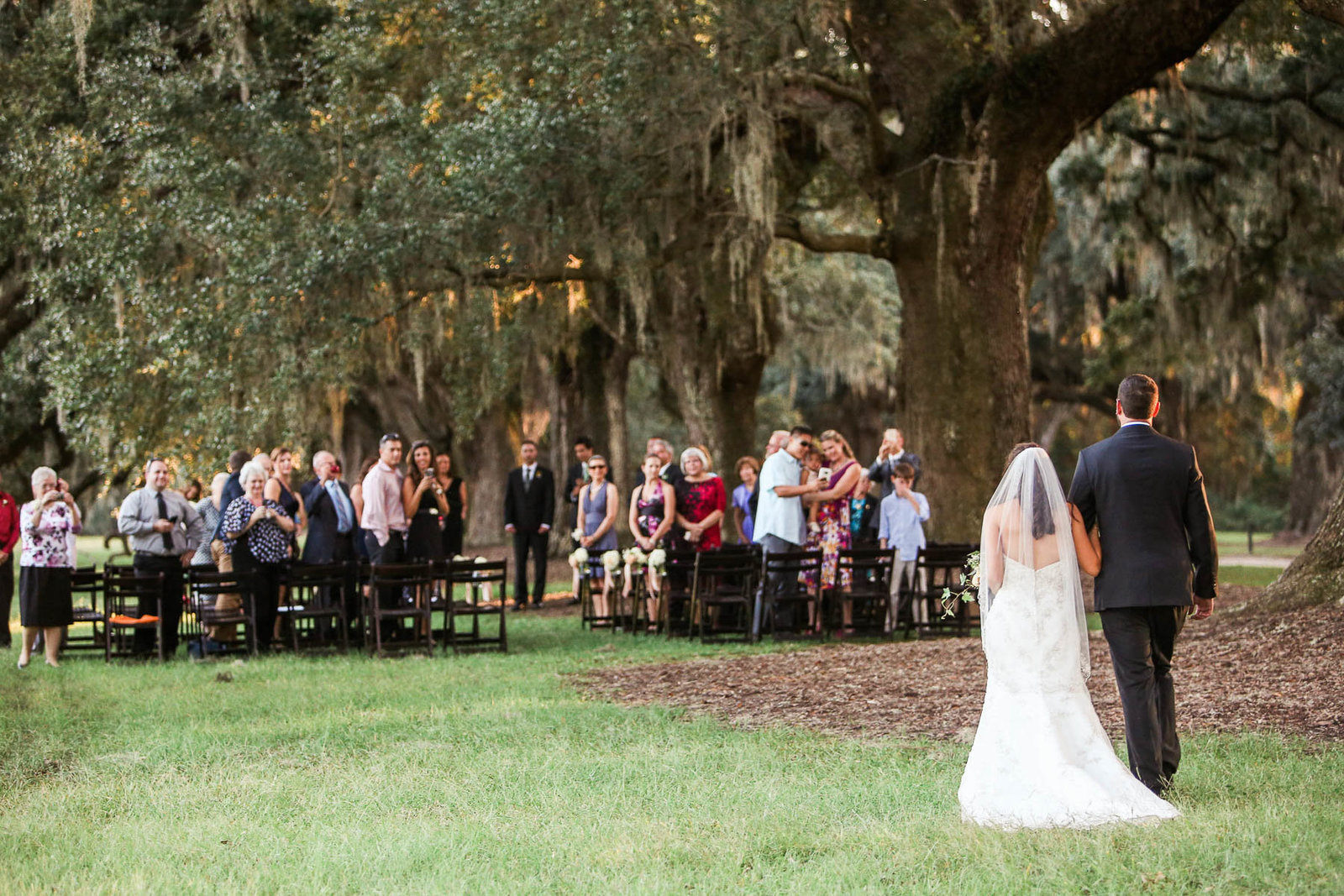 Brother walks bride down the aisle, Boone Hall Plantation, Charleston, South Carolina. Kate Timbers Photography.