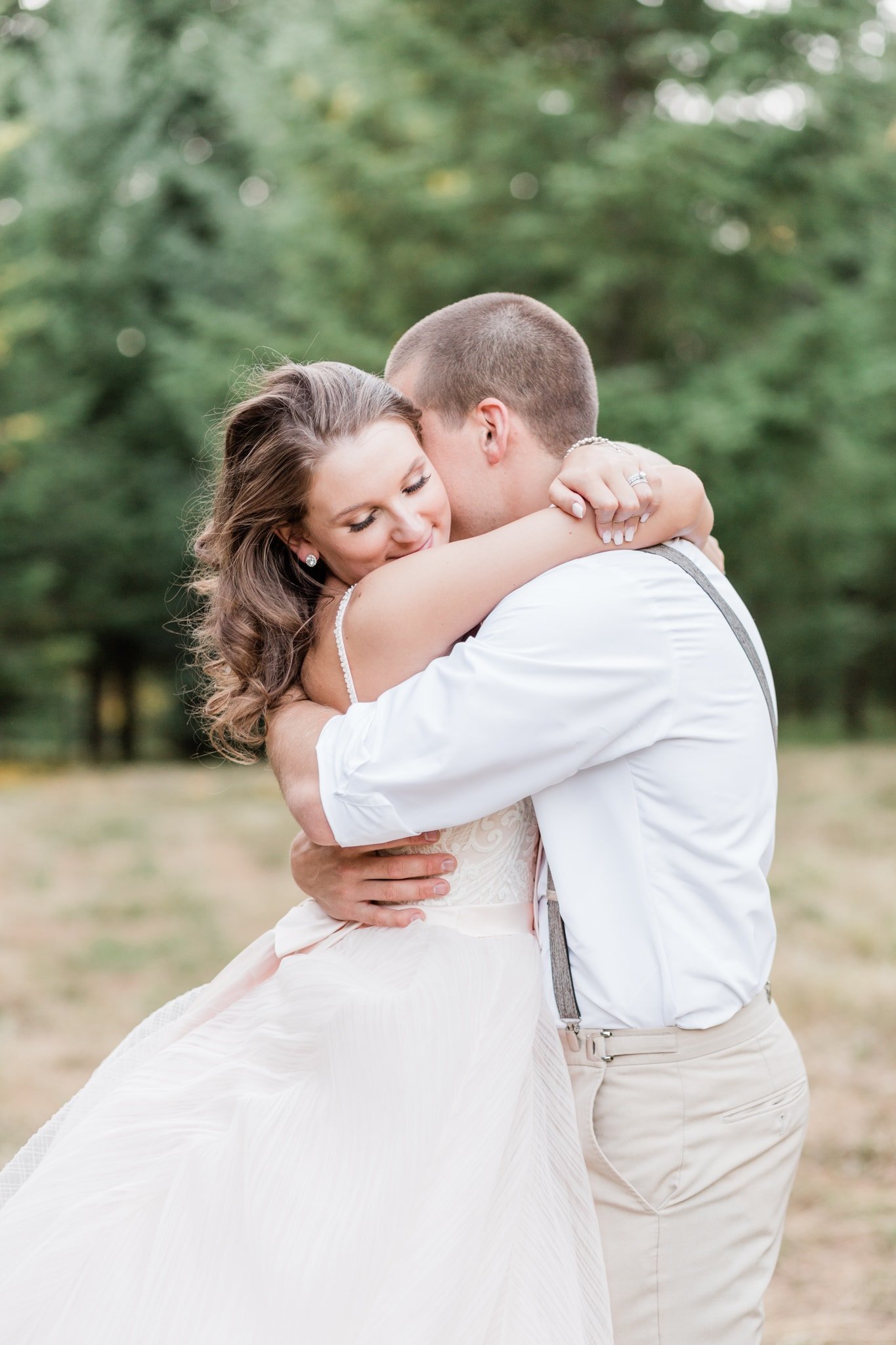 Bride and Groom hug during sunset photos