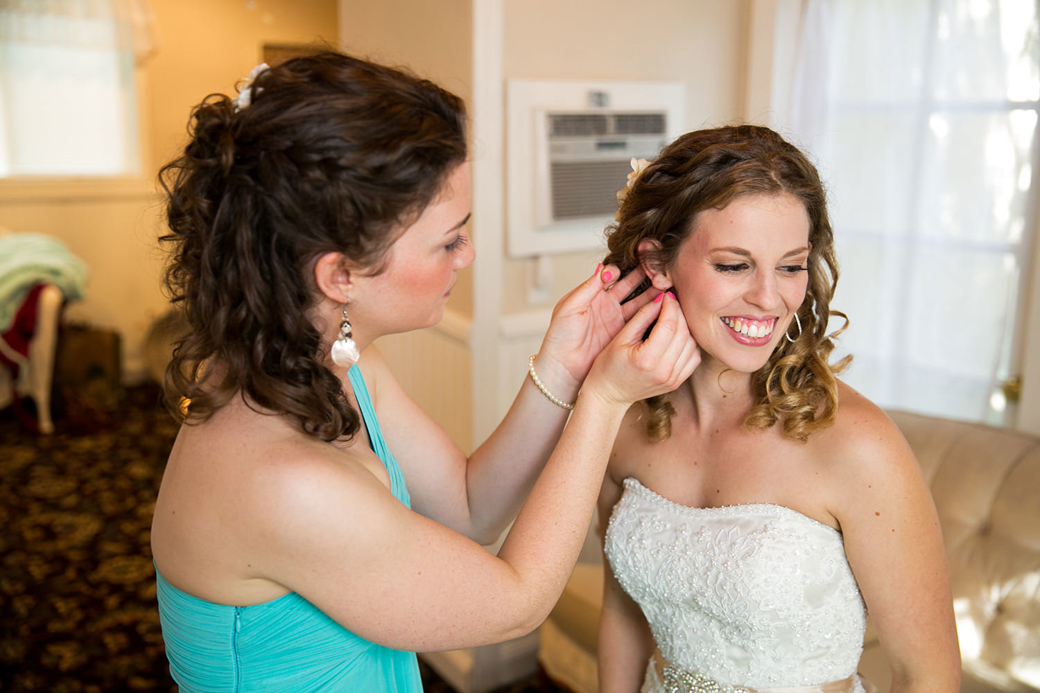 bride getting ready with earrings