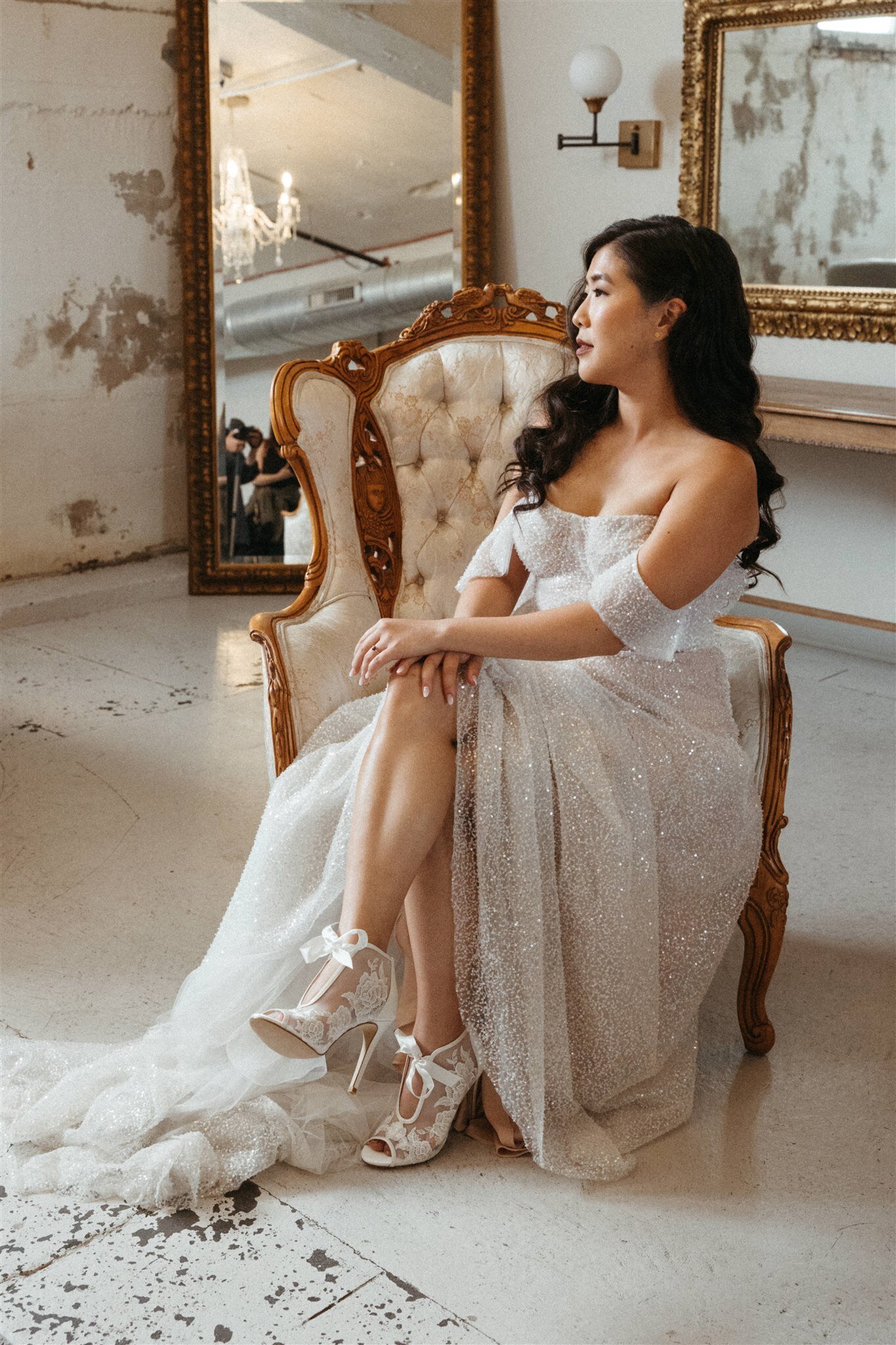 Bride relaxing in long bridal gown iin the bridal suite at the St Vrain wedding venue