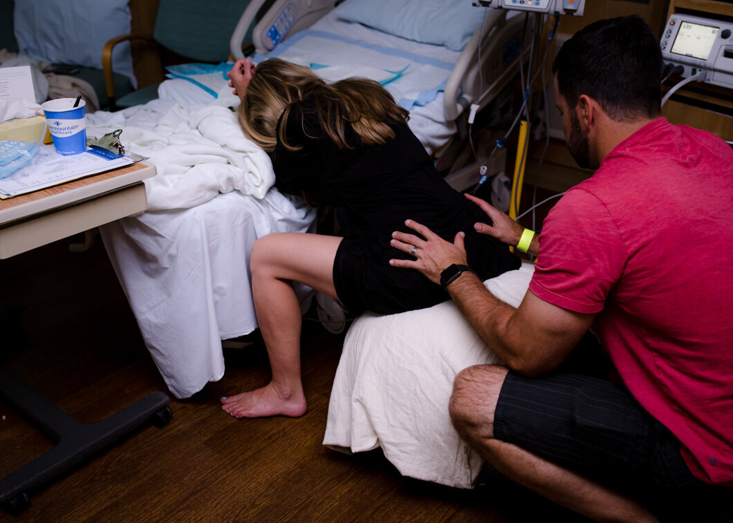A mother labors in the hospital with spouse support. Photo by Diane Owen