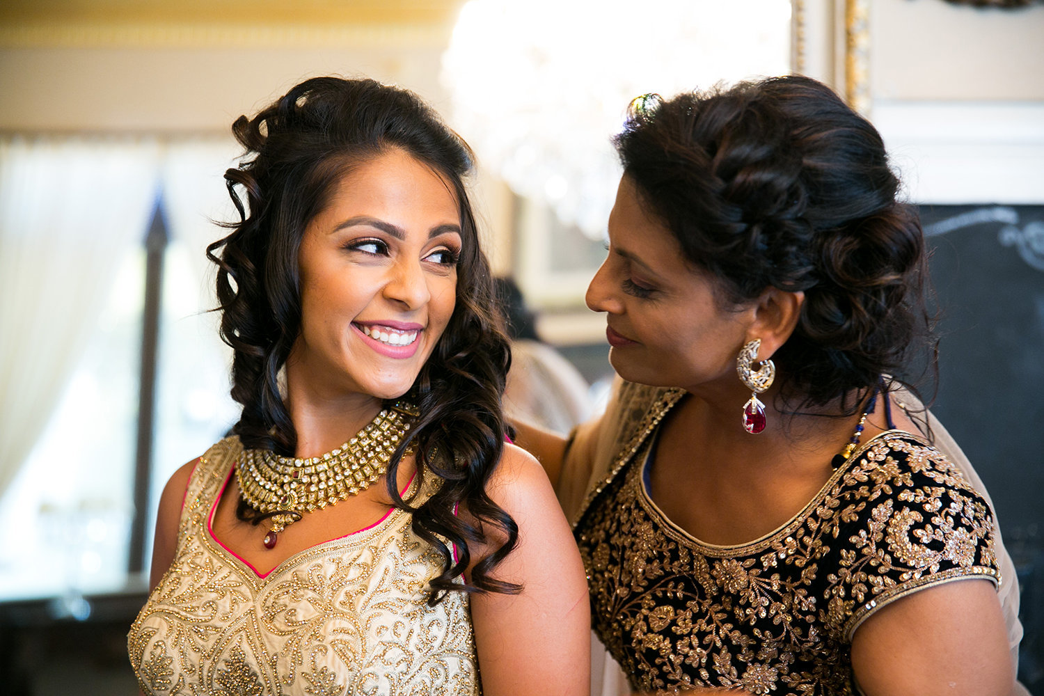 Sweet moment between mother and daughter before Hindu Indian wedding ceremony