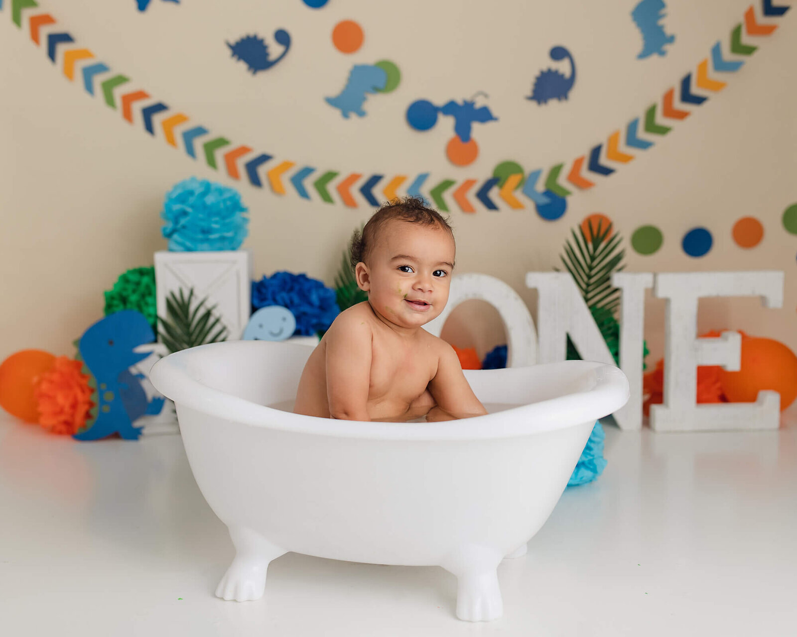 Baby boy Smiling in bath after cake smash, Davenport Cake smash photographer, First birthday pictures in the quad cities, Bettendorf cake smash Photography, cake smash photographers davenport