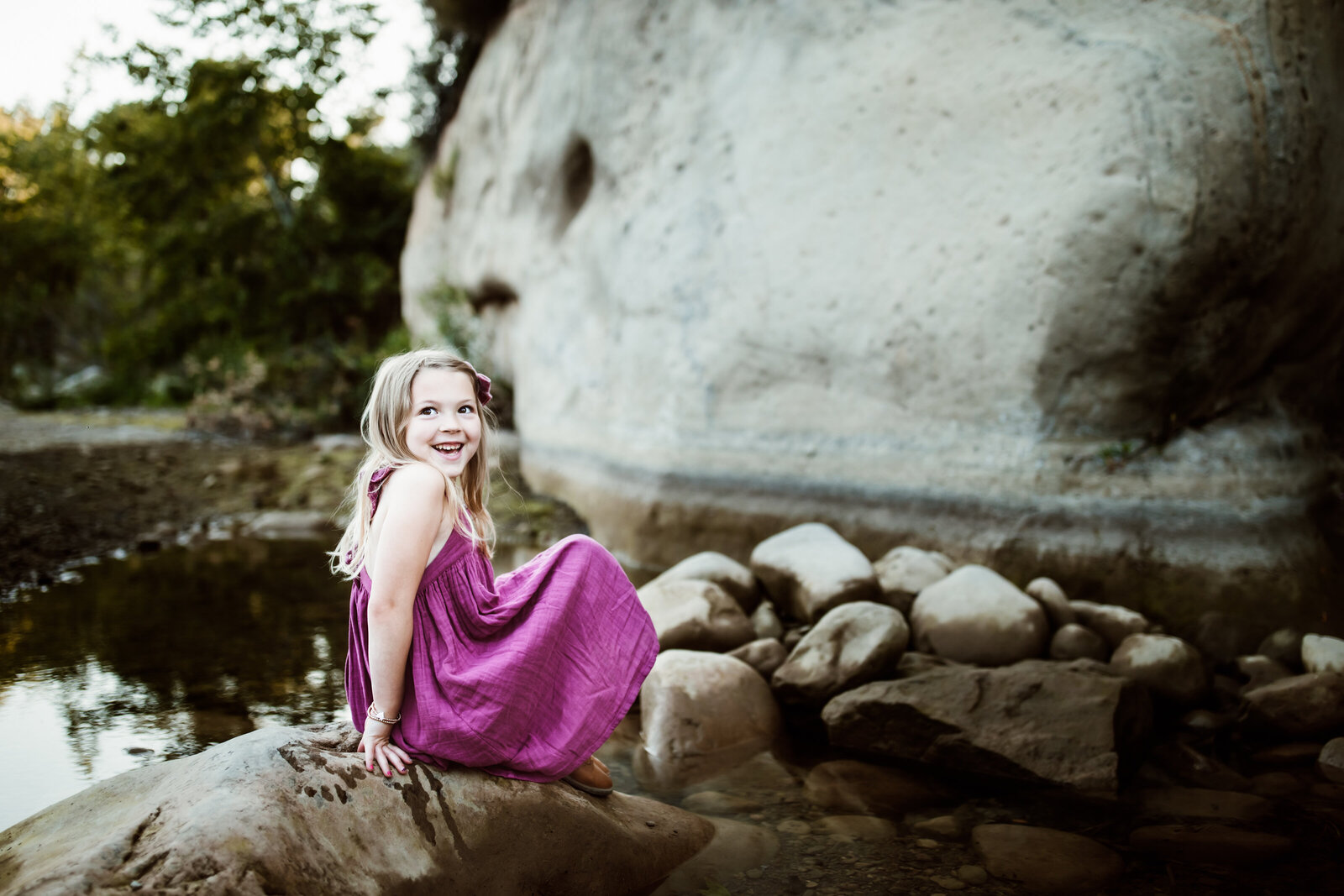 untitled-220430-105-EditFamily-Photo-Santa-Barbara-County-Girl-sitting-rock-water-smiling-purple-dress