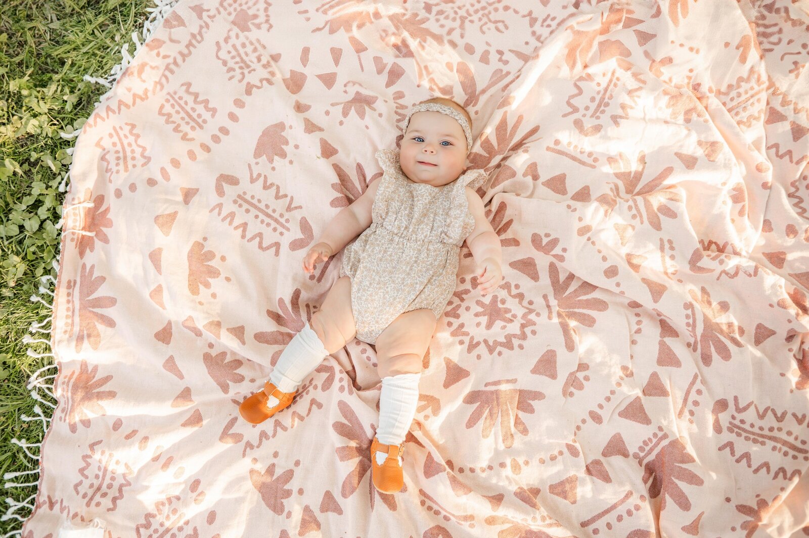 6 month old on  pink blanket