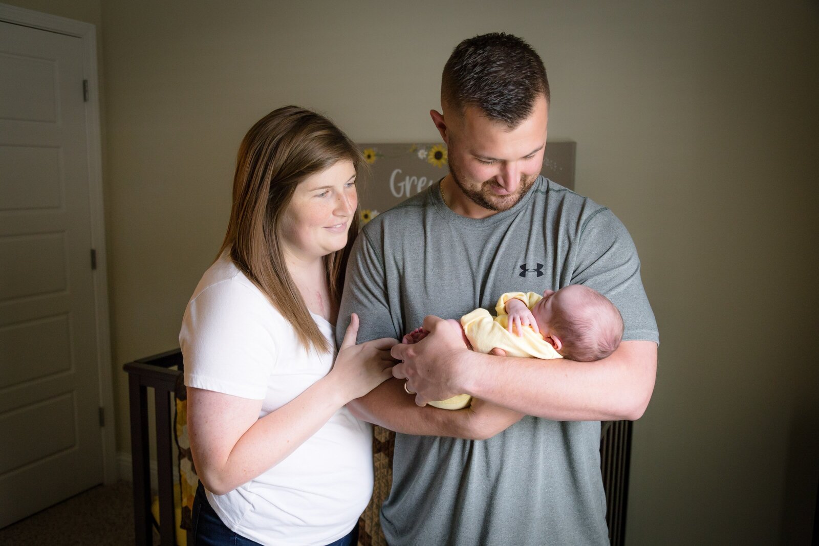 Family holding newborn during in-home newborn session.