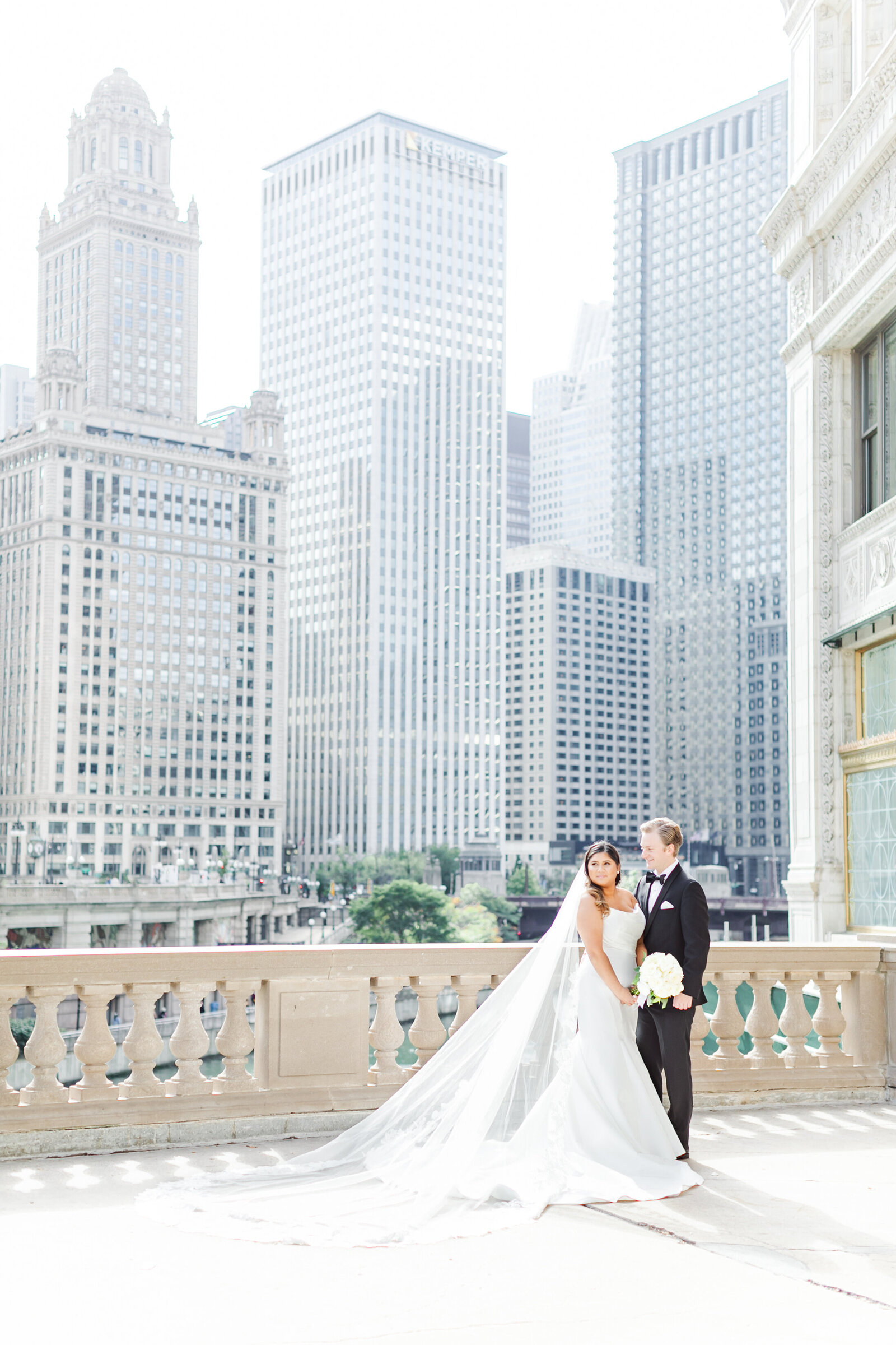 69_bride_and_groom_downtown_chicago_illinios_building_behind_them