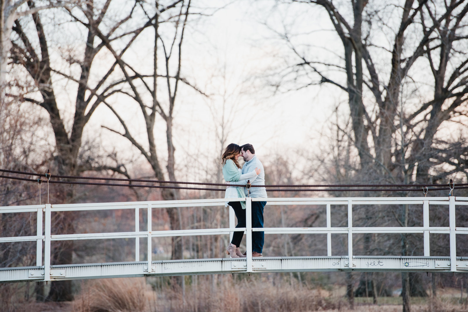 couple on bridge during chicago engagement photos