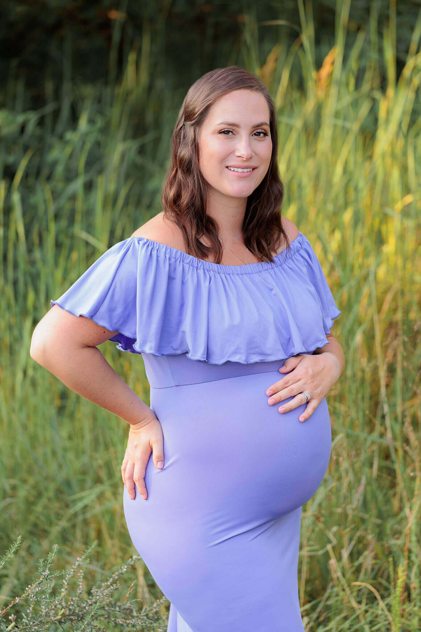 A beautiful pregnant woman posing for the camera during her maternity portraits in Fairfax County, VA.