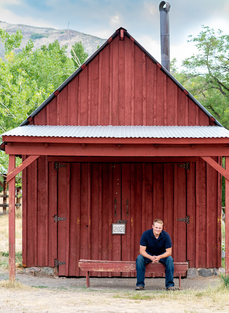 senior with red barn