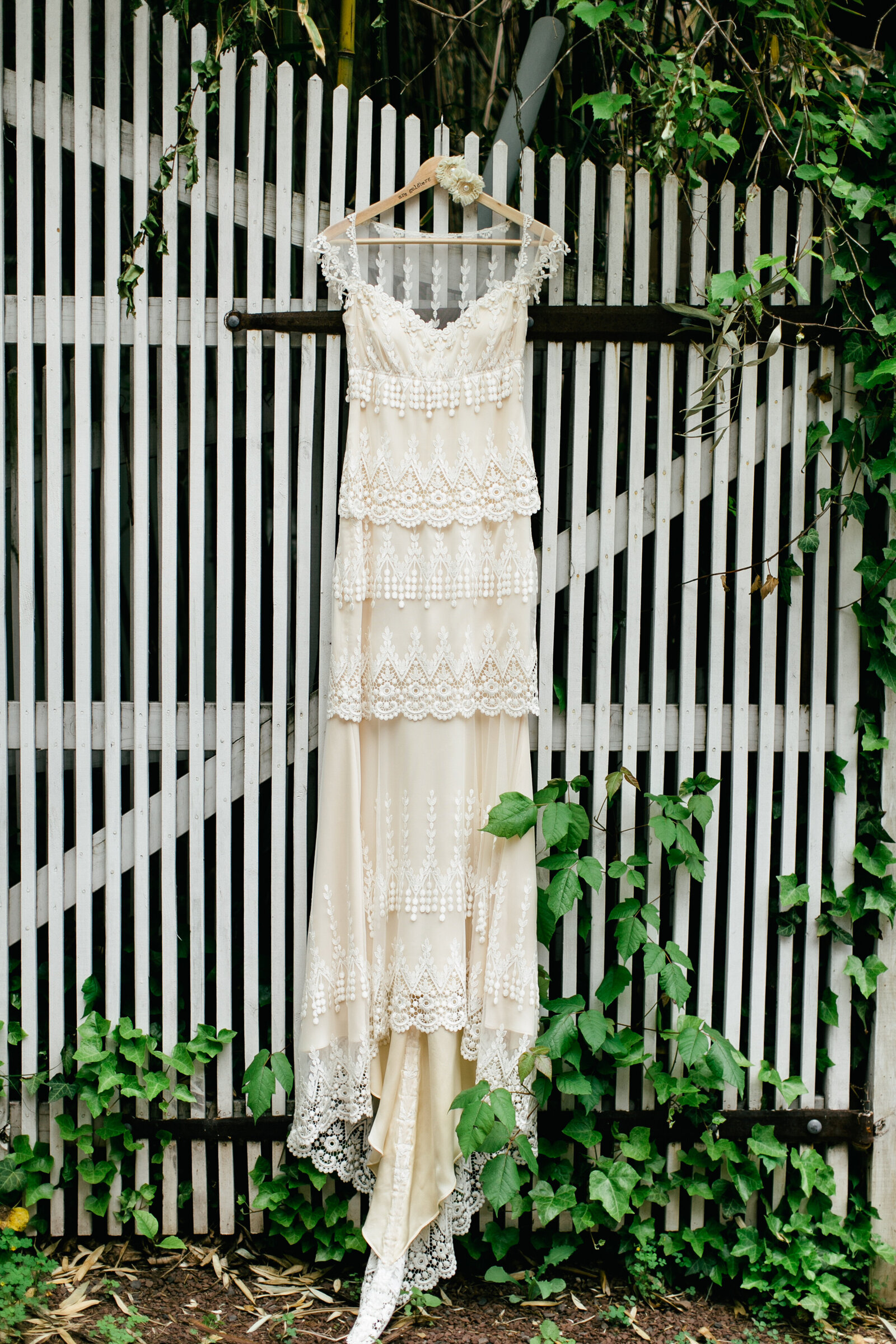 brides lace wedding dress hanging outside