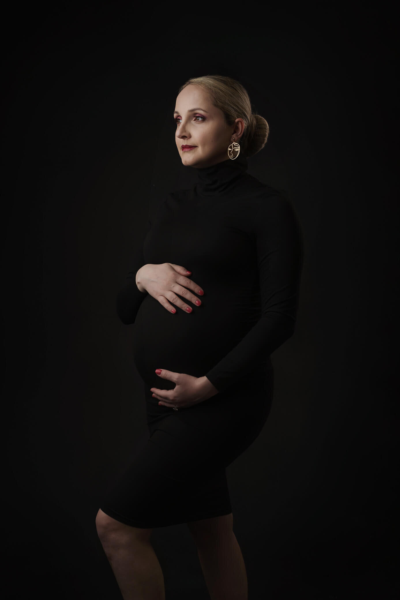 maternity mom wearing black turtle neck  dress