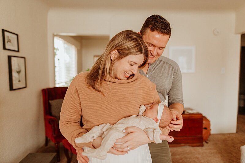 Mom and dad with baby girl at vancouver newborn photography session