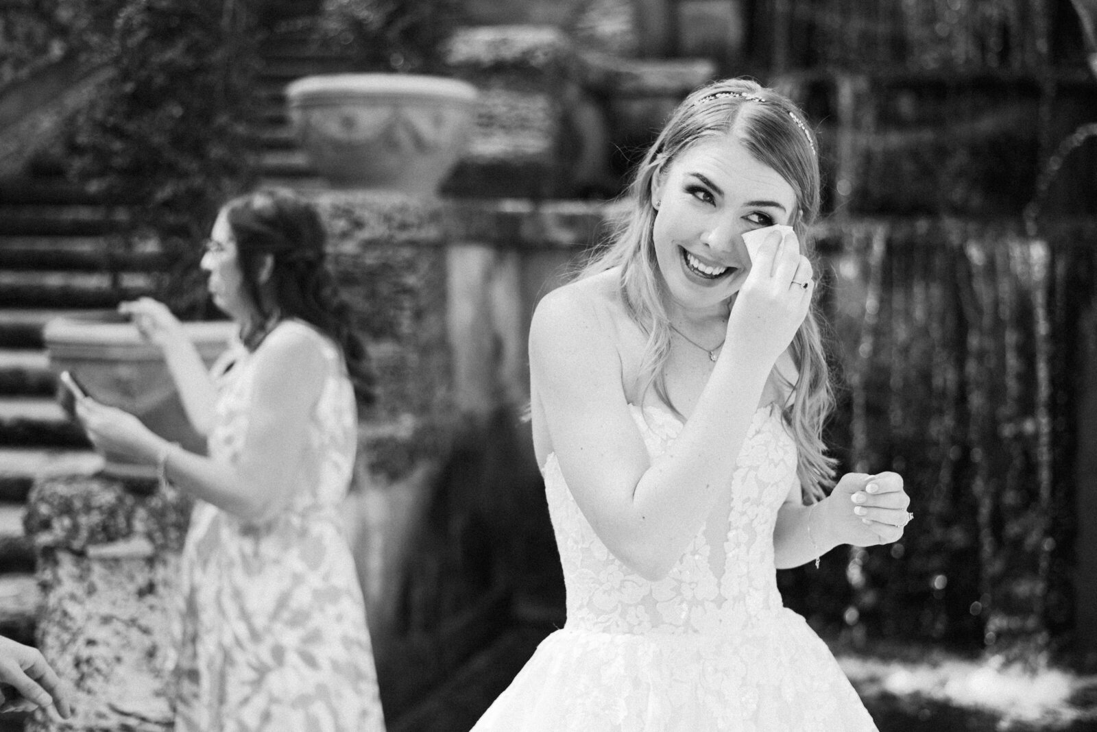 Bride wiping her eyes after her wedding ceremony.