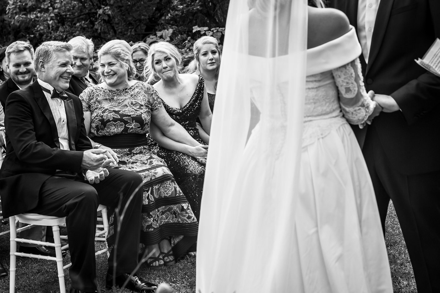Family laughing and smiling during outdoor wedding ceremony